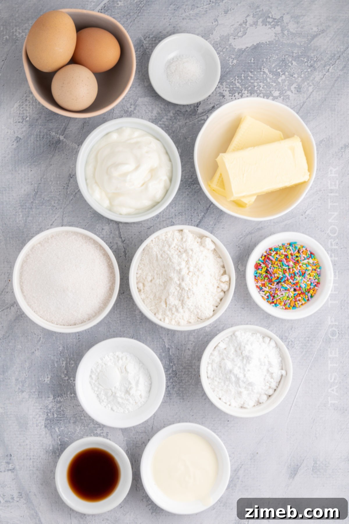Festive Funfetti Cupcakes 4 Ingredients for Sprinkle Cupcakes - array of fresh baking ingredients including butter, sugar, eggs, flour, and colorful sprinkles
