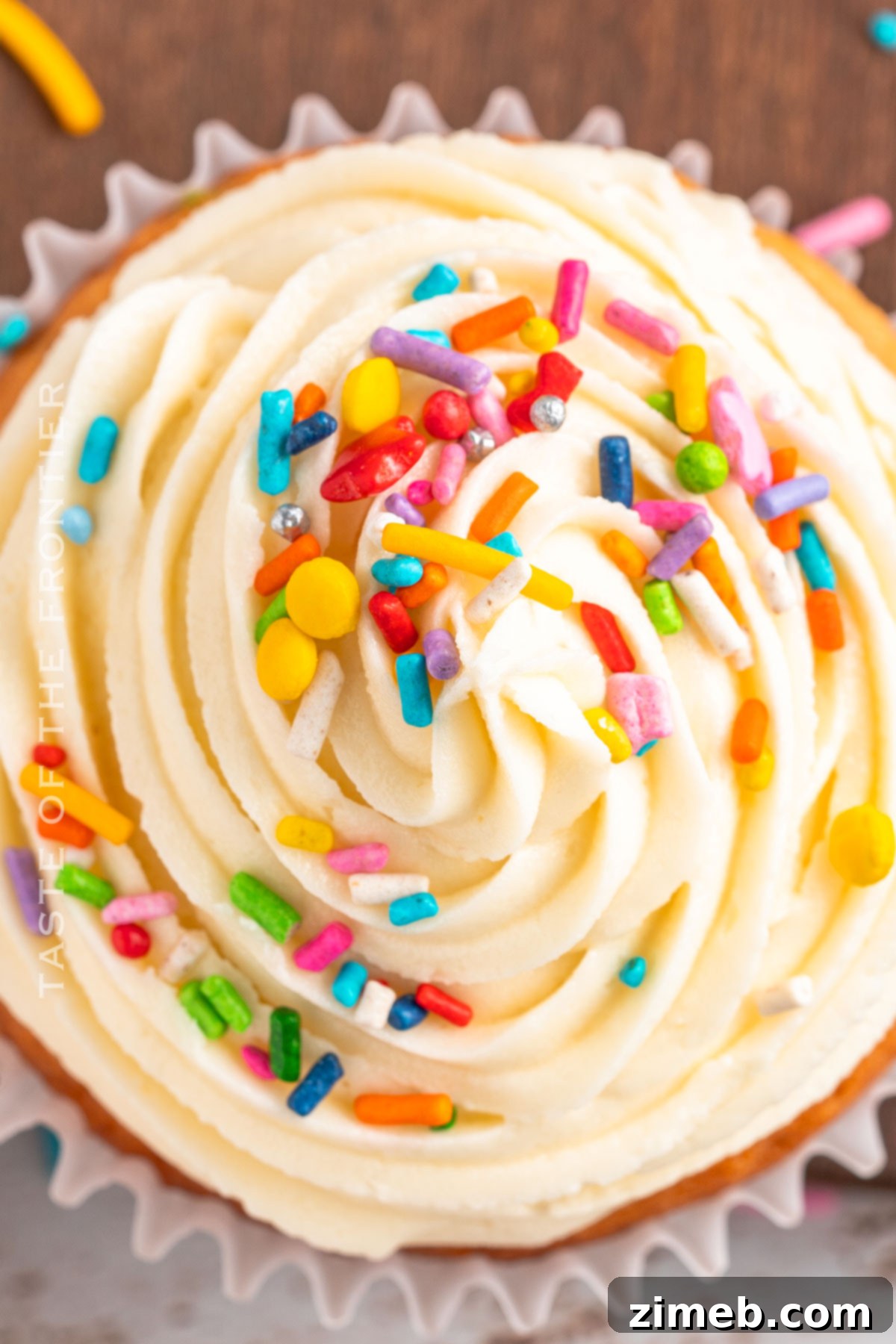 Festive Funfetti Cupcakes 9 Decorated cupcake with sprinkles - a single, perfectly frosted vanilla cupcake adorned with colorful sprinkles