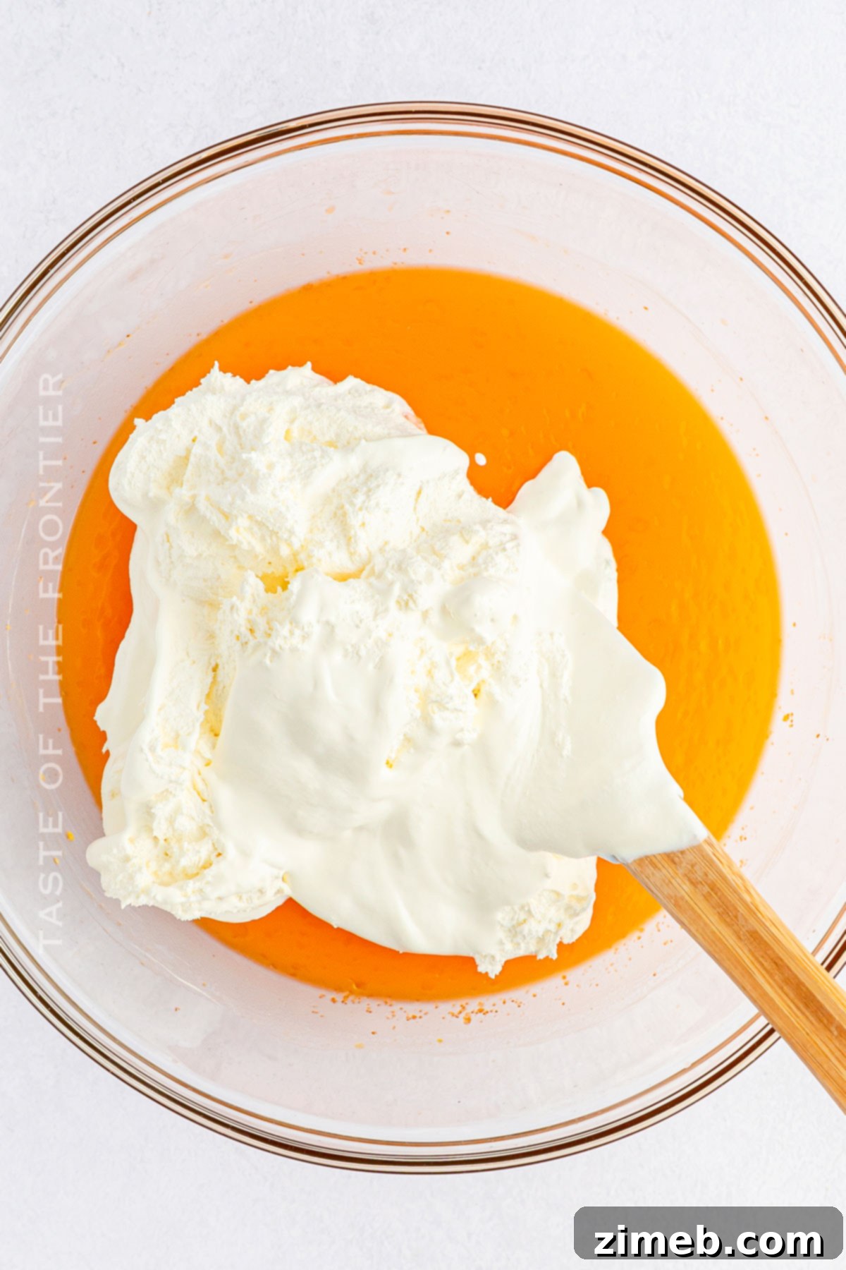 Citrus Cloud Delight 6 Adding Whipped Topping to Orange Fluff Salad