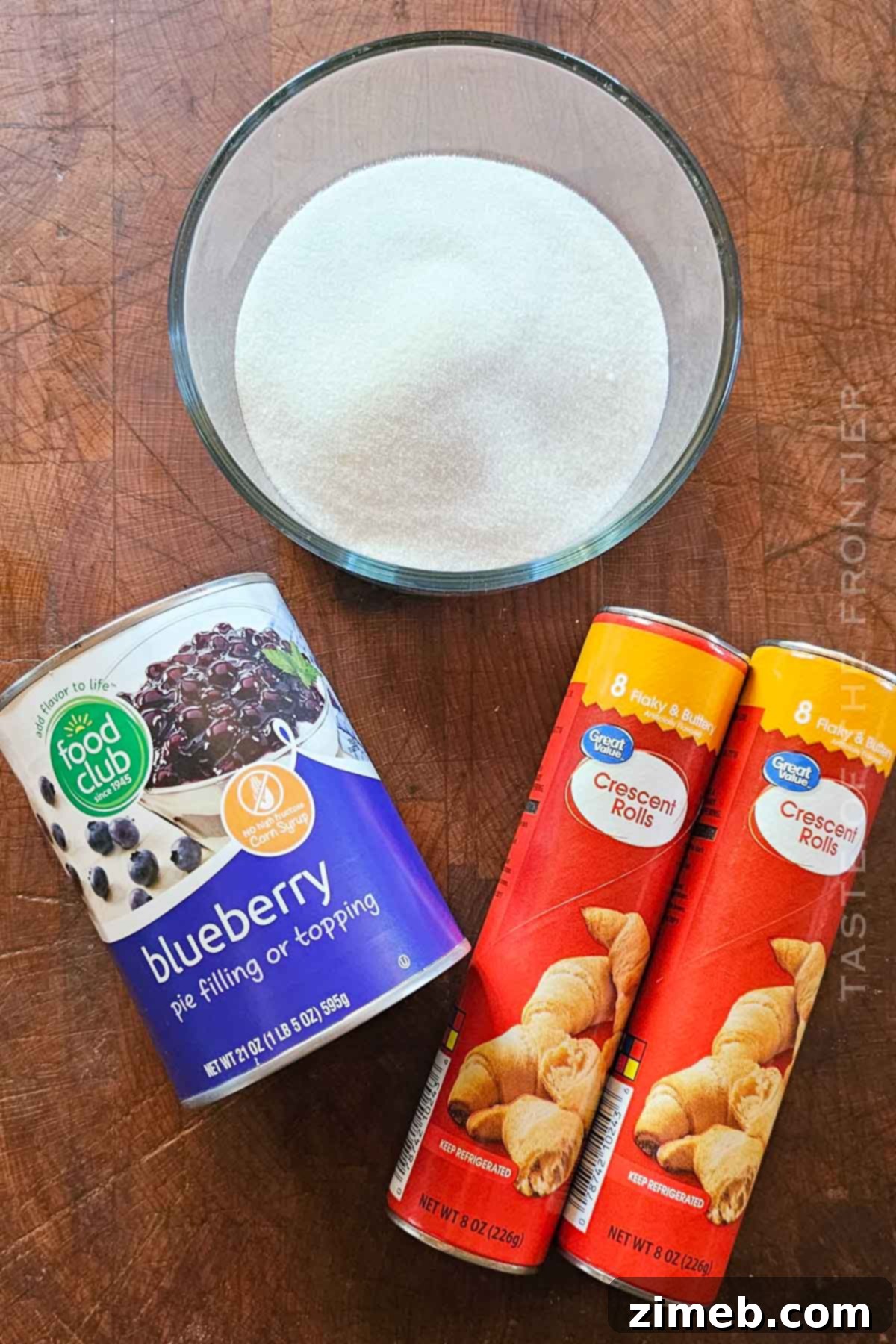 Blueberry Bliss Cruffins 4 Ingredients for making Blueberry Cruffins: crescent roll dough, blueberry pie filling, and granulated sugar.