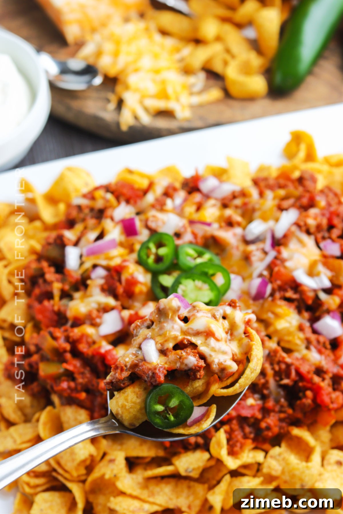 Chili Chip Comfort Bowl 16 Delicious Frito Chili Pie recipe ready to be enjoyed, showcasing the layers of chips, chili, and cheese