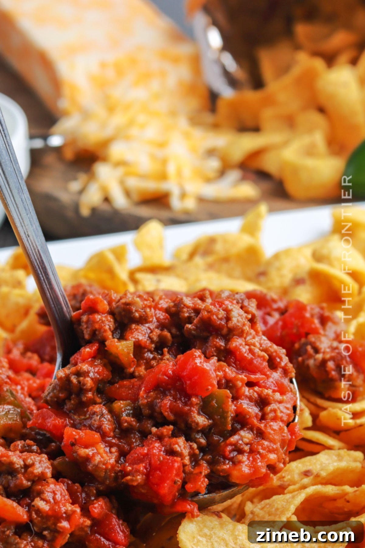 Chili Chip Comfort Bowl 7 Frito Chili Pie topped with fresh ingredients like cilantro and sour cream, ready for serving