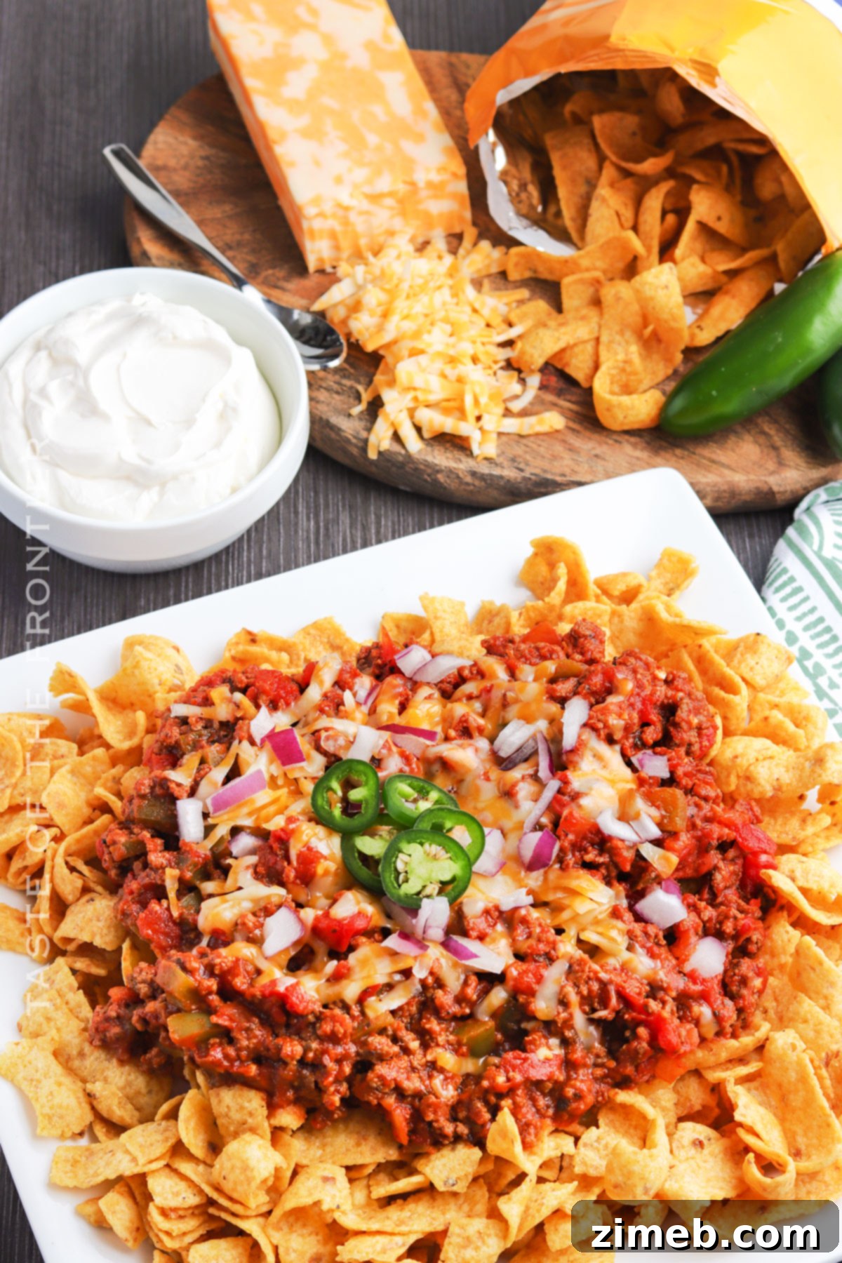 Chili Chip Comfort Bowl 8 A hearty Frito Chili Pie dinner served in individual bowls, topped with sour cream and green onions