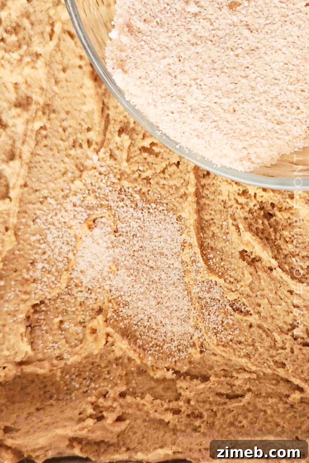 Adding cinnamon and sugar to Churro Bars.