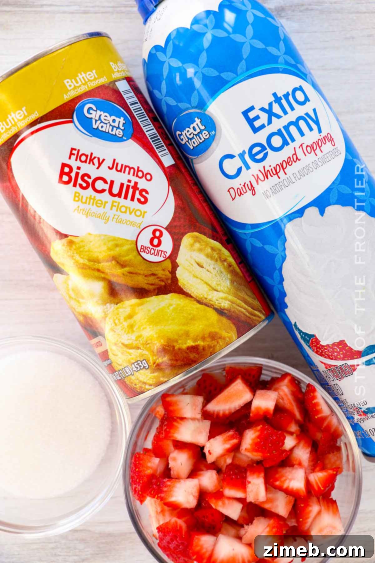 Golden Air Fryer Strawberry Shortcake Bliss 4 Air Fryer Strawberry Shortcake ingredients laid out, highlighting fresh strawberries and biscuits.