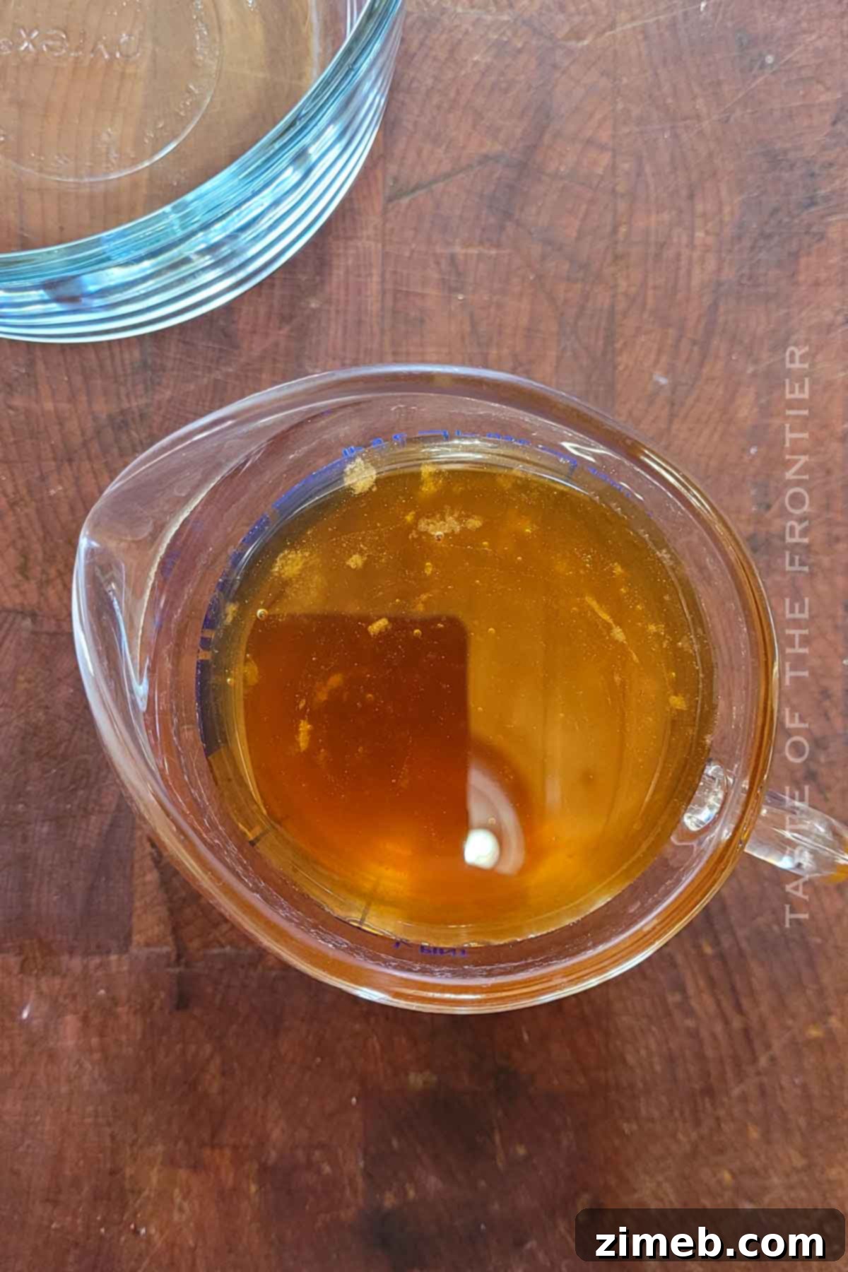 Embered Nectar 4 Honey in a measuring cup, ready for the smoking process to make smoked honey