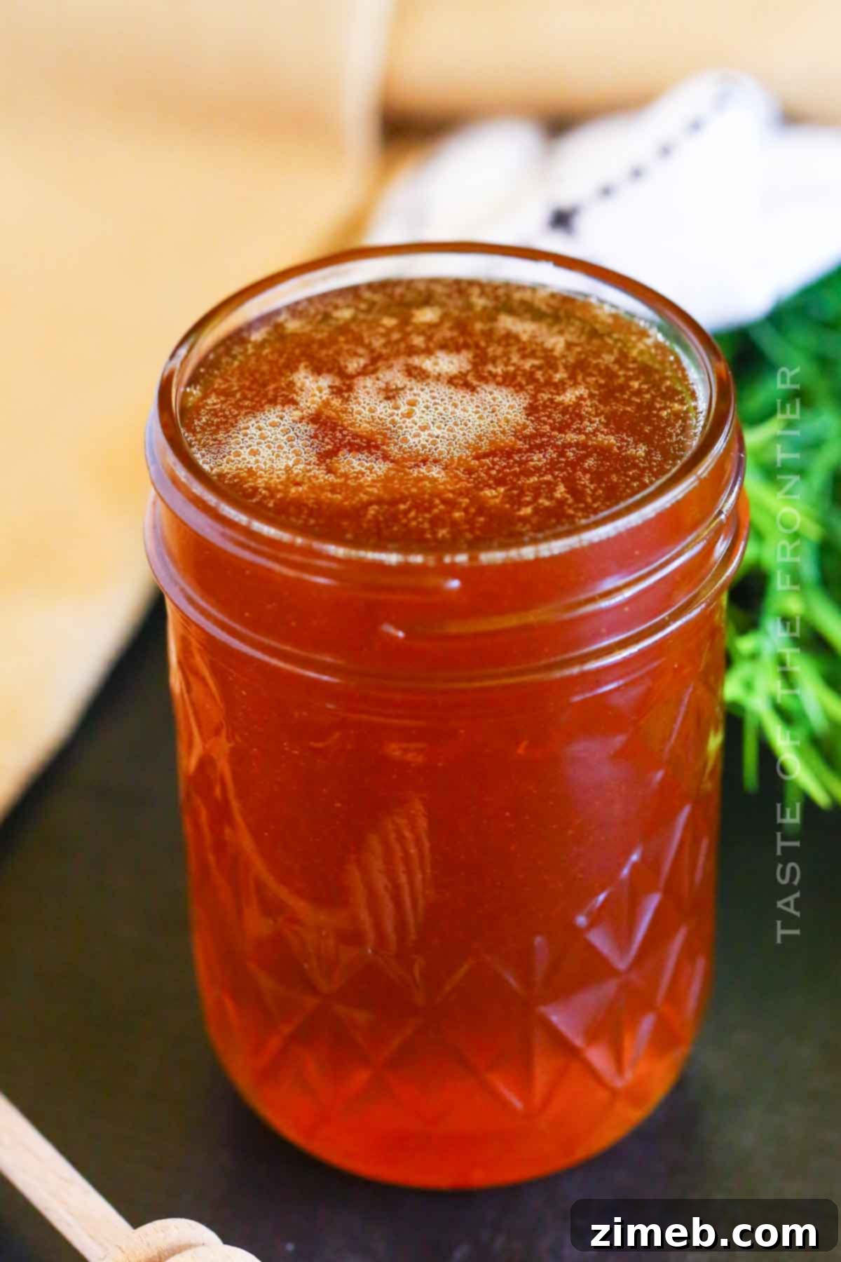 Embered Nectar 8 Jar of smoked honey with a honey dipper, showcasing its golden color