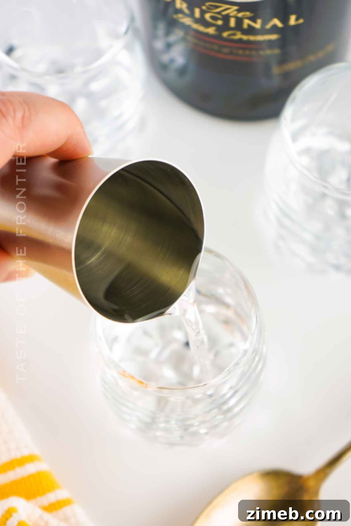 Close-up of a layered Buttery Nipple shot glass with butterscotch schnapps base