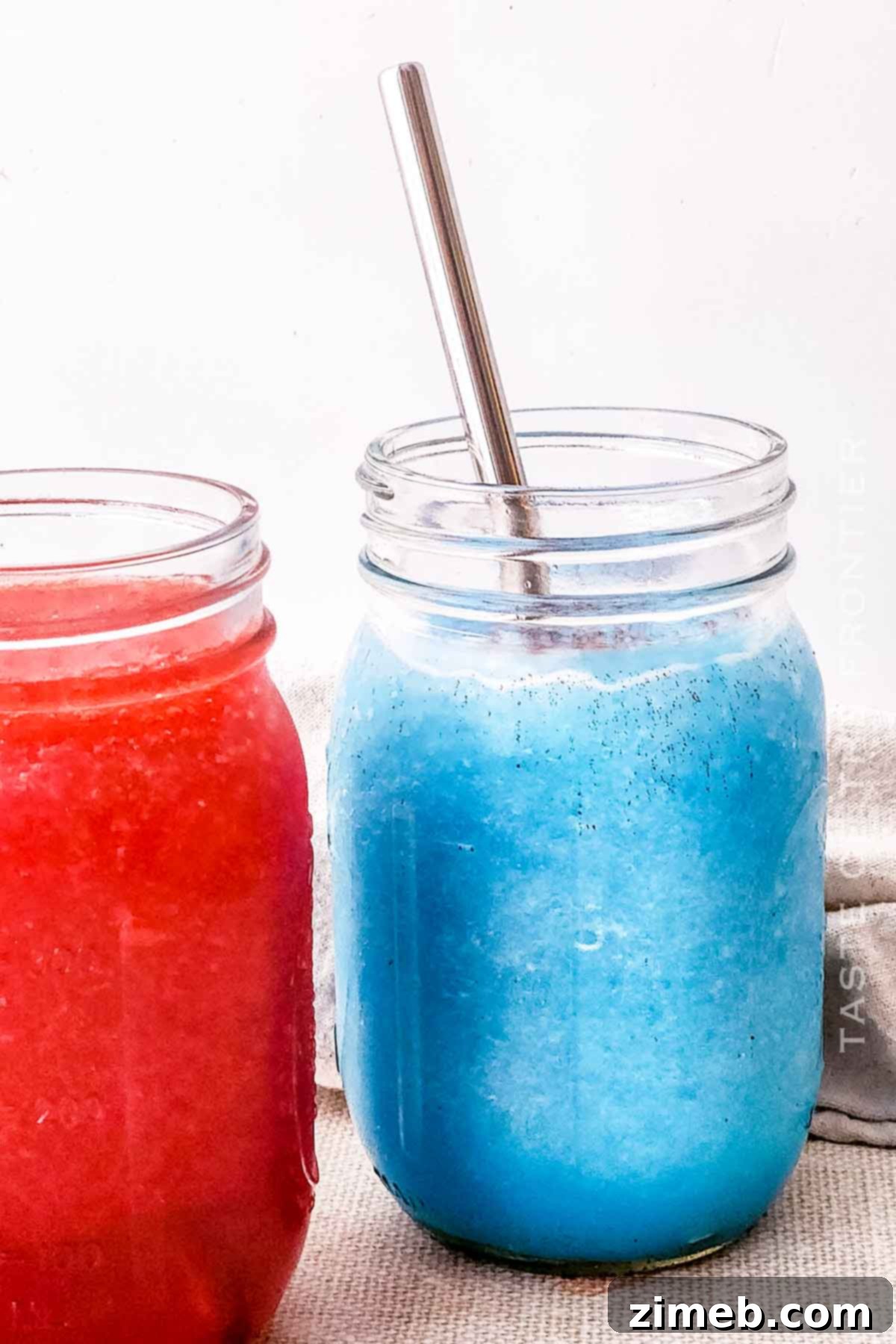 Whip Up Your Own Refreshing Kool-Aid Slushie 3 TikTok slushie - a purple Kool-Aid slushie in a clear cup with whipped cream and sprinkles