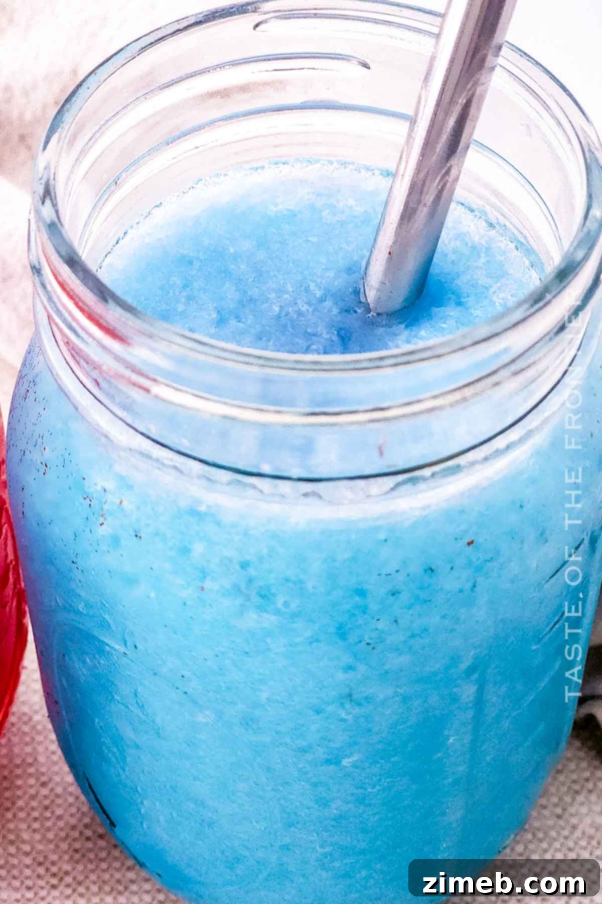 Whip Up Your Own Refreshing Kool-Aid Slushie 7 Blue raspberry slurpee in a glass with a bright blue hue