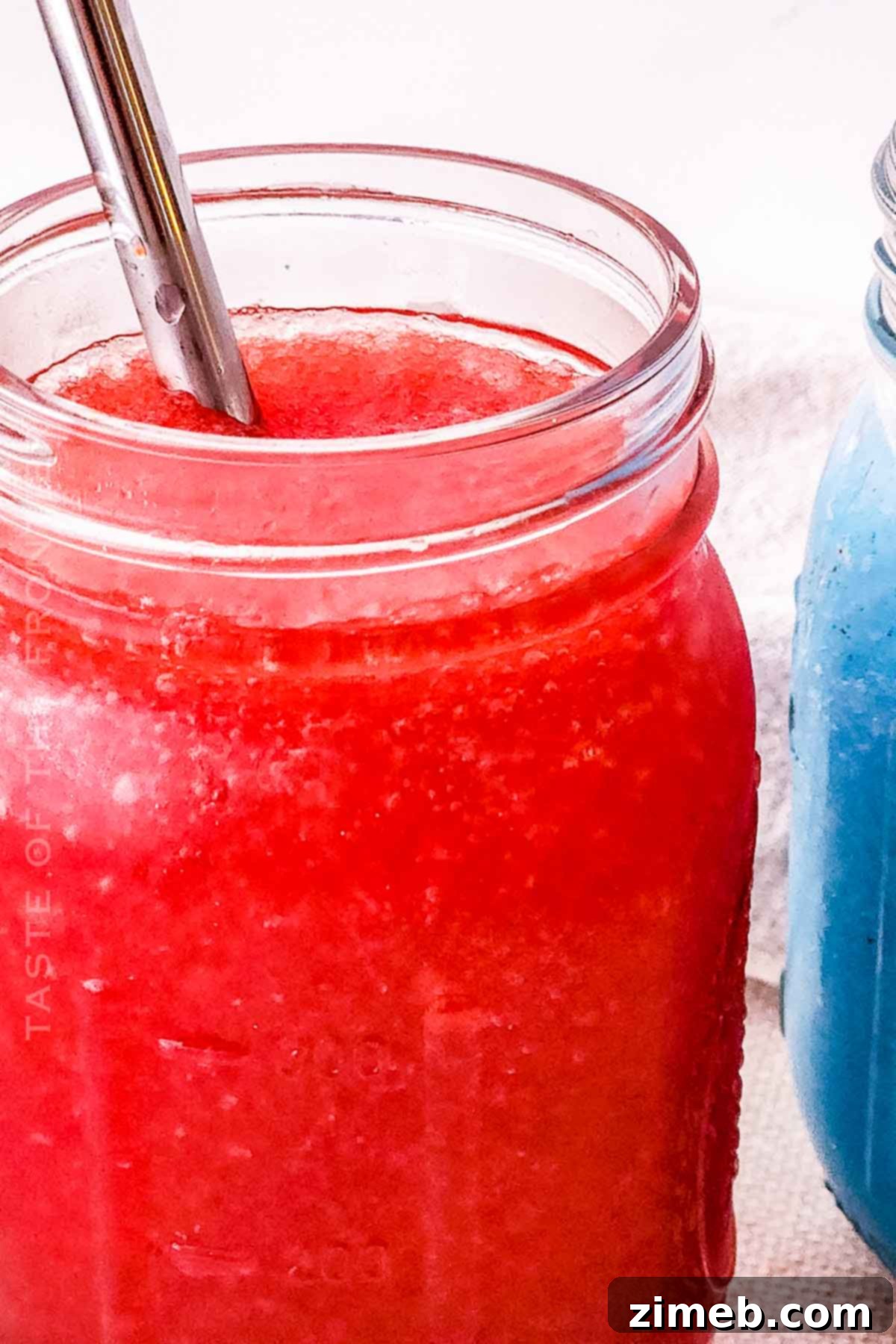 Whip Up Your Own Refreshing Kool-Aid Slushie 8 Cherry slurpee in a glass, vibrant red