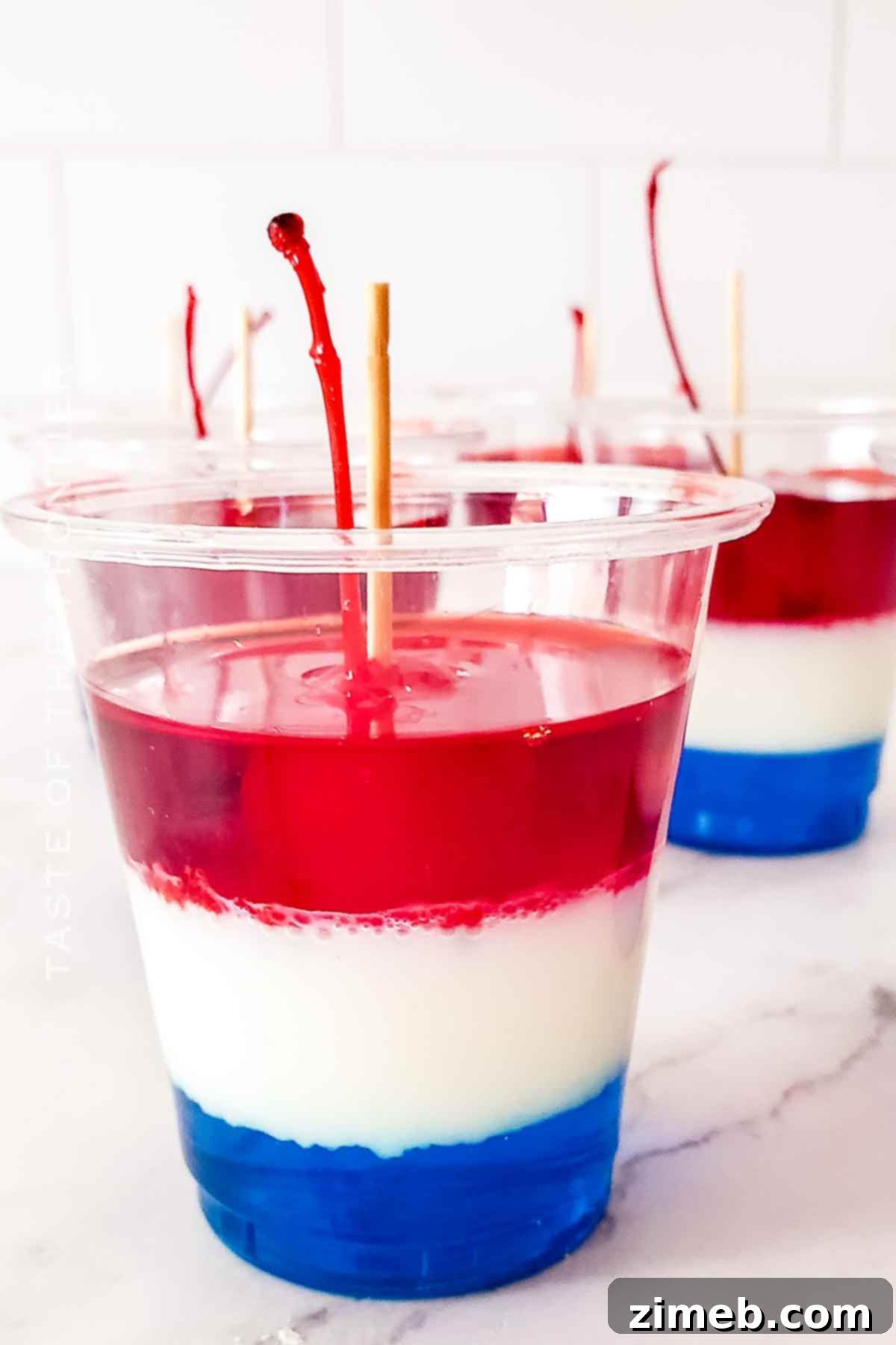 Vibrant red, white, and blue Bomb Pop Jello Shots arranged on a platter, ready for summer celebrations.