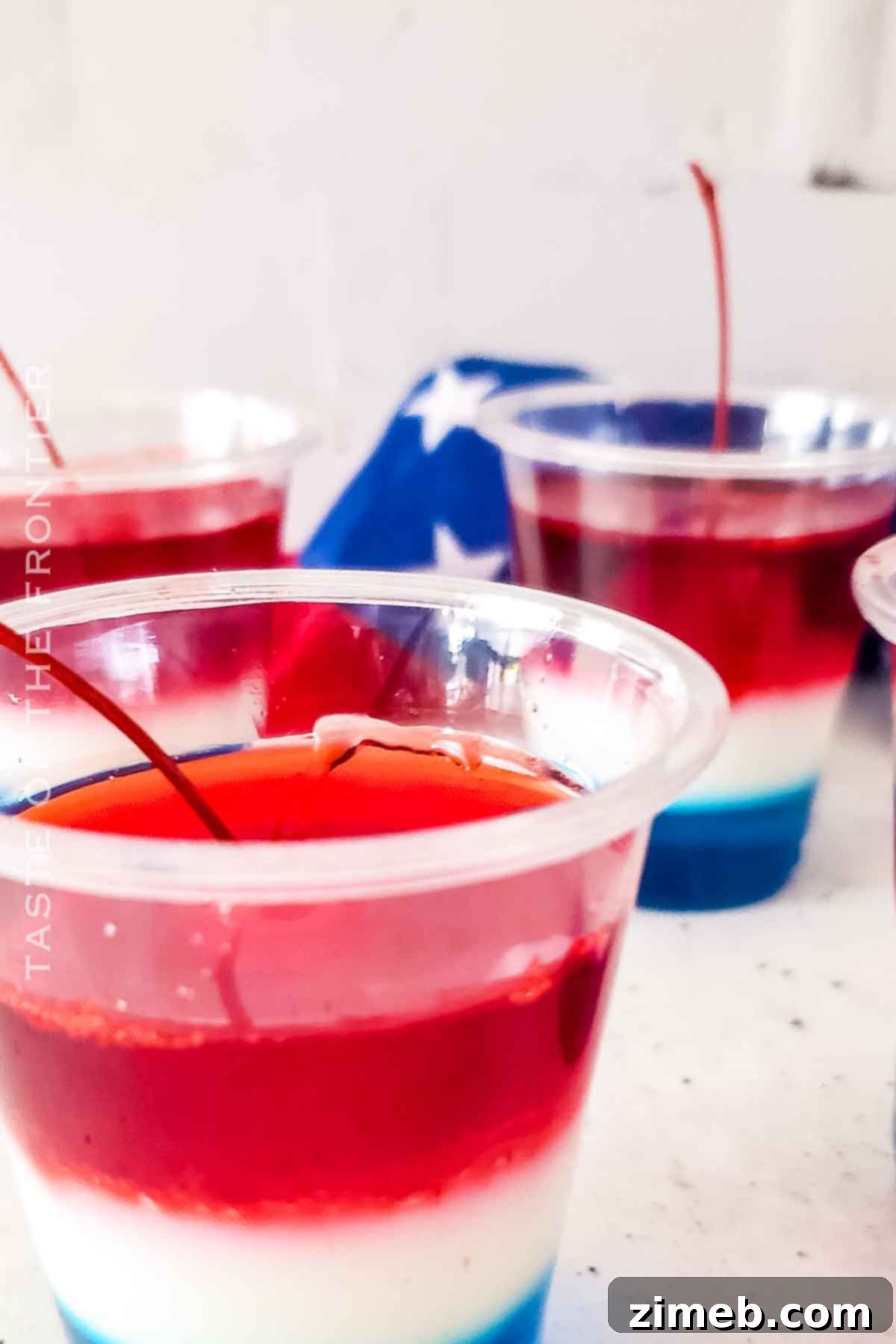 Close-up of a single Bomb Pop Jello Shot, showcasing the distinct red, white, and blue layers, perfect for Fourth of July.