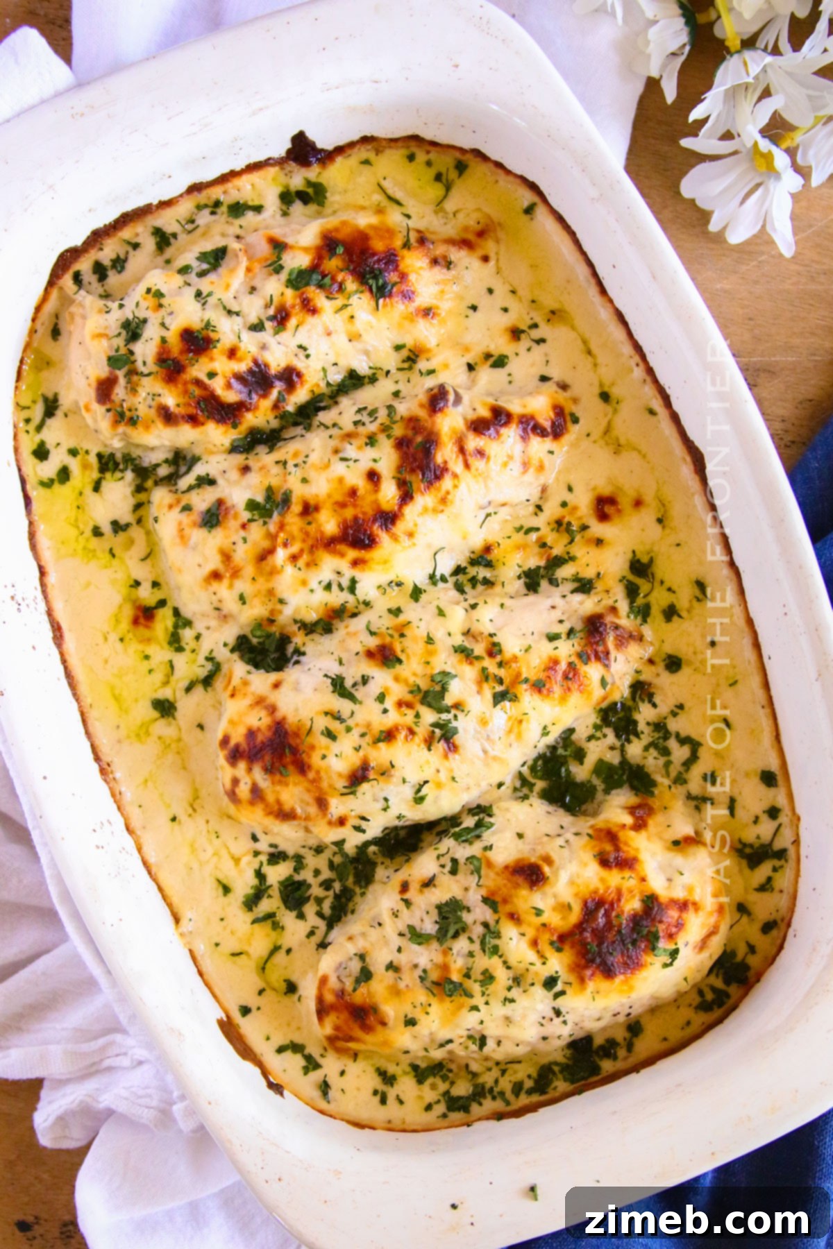 Creamy Mushroom Chicken 3 Easy baked chicken in a cheesy mushroom sauce, garnished with fresh herbs.