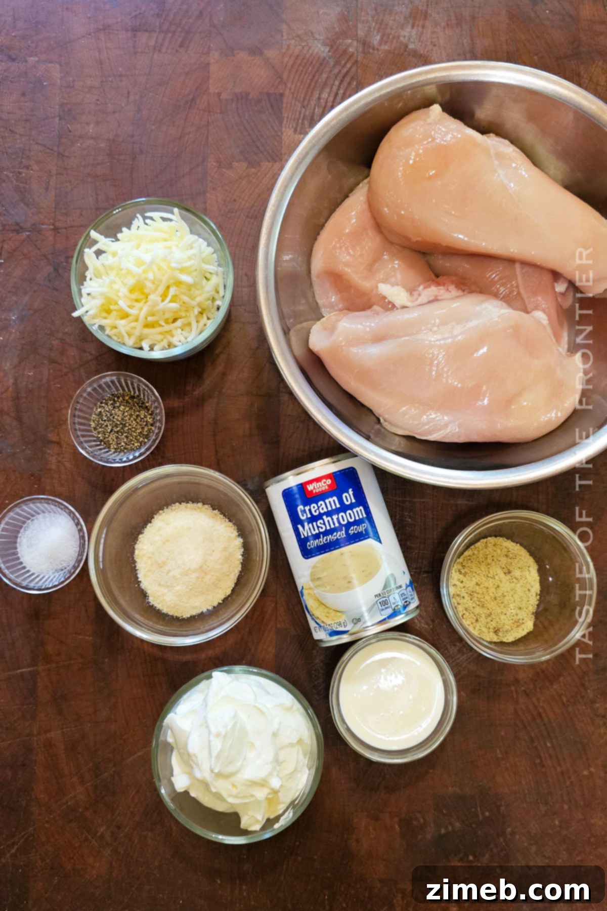 Creamy Mushroom Chicken 4 Ingredients laid out for Cream of Mushroom Chicken recipe, including chicken breasts, soup, sour cream, cheese.