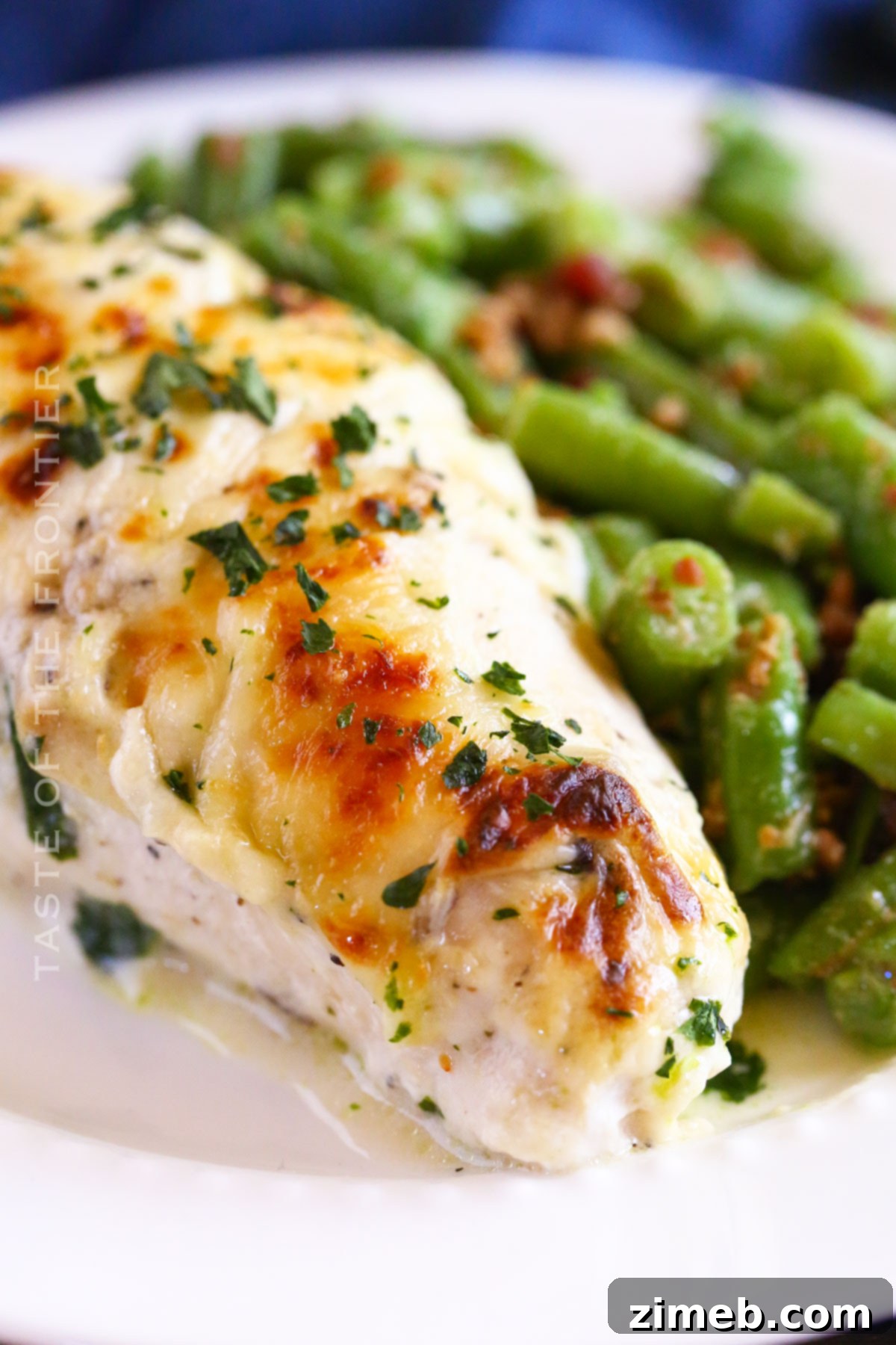 Creamy Mushroom Chicken 8 Baked chicken dinner with creamy mushroom sauce and cheese, served with a side of green beans.
