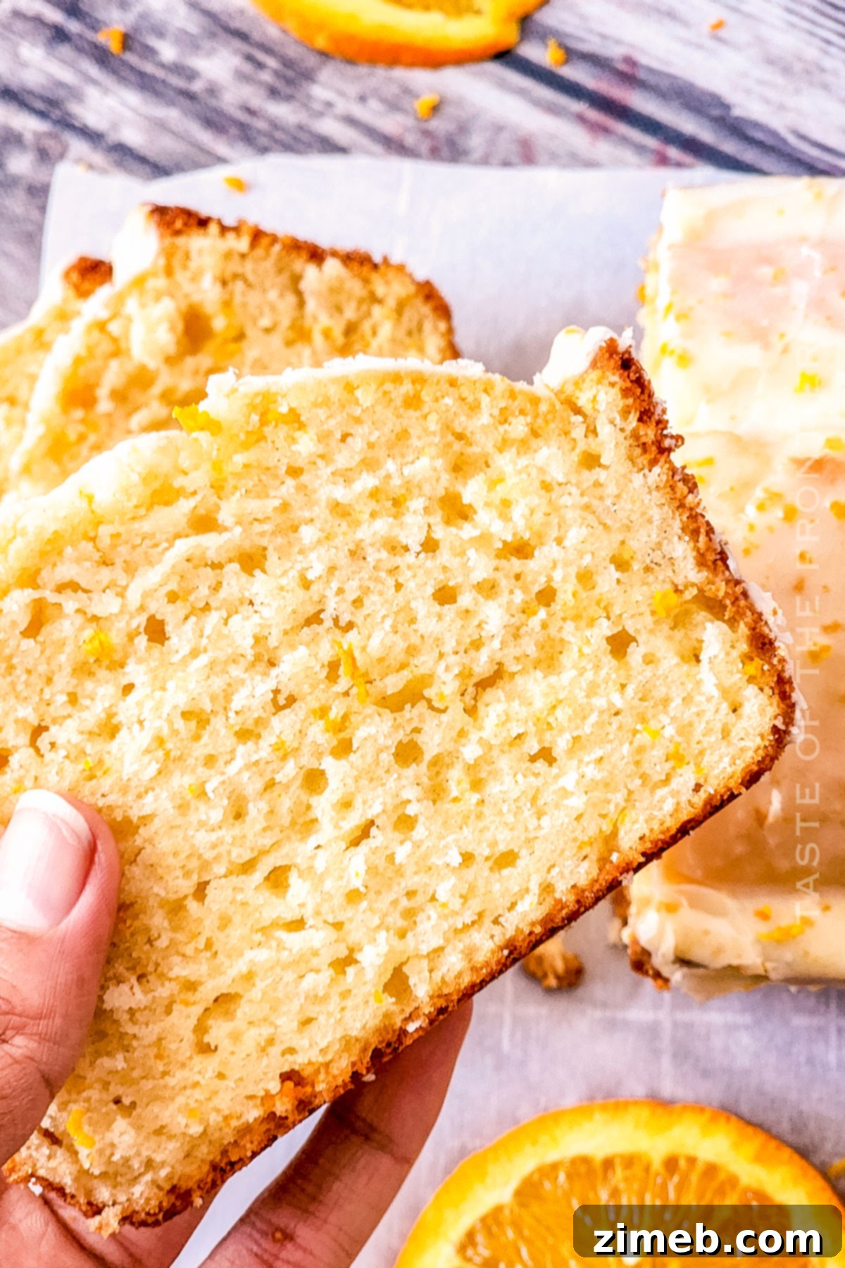 Zesty Orange Loaf 15 A perfectly sliced piece of orange cake, showing its moist texture and vibrant color.