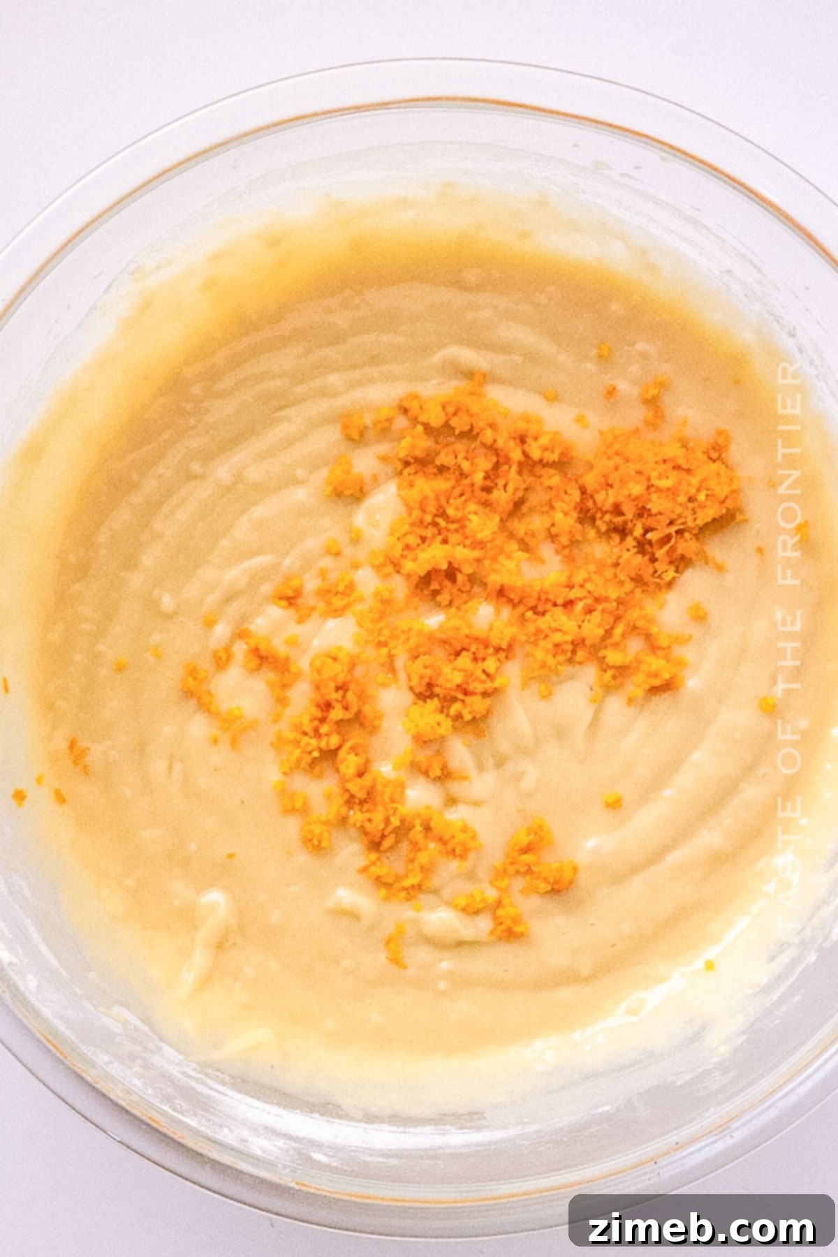 Zesty Orange Loaf 4 Orange cake batter being mixed in a bowl.