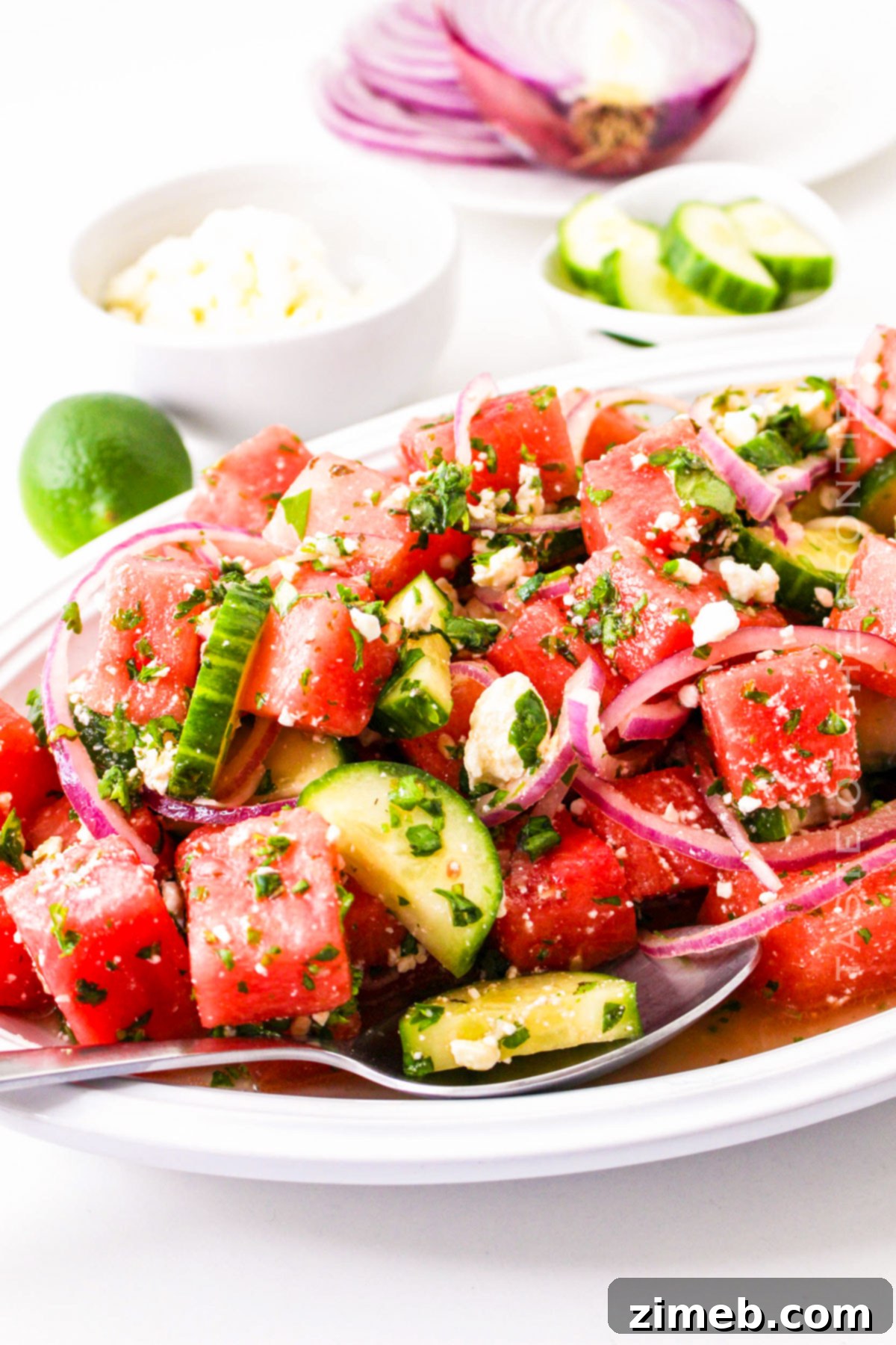 Beautifully arranged Watermelon Salad with Goat Cheese, emphasizing its role as a perfect summer side dish.