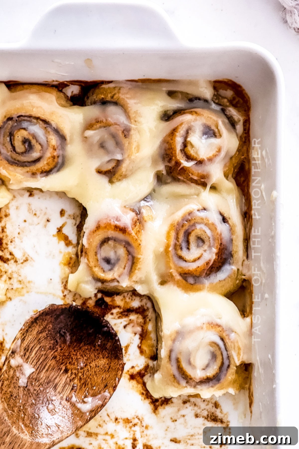 A close-up of a single 30 minute breakfast roll, featuring its flaky layers and gooey center.