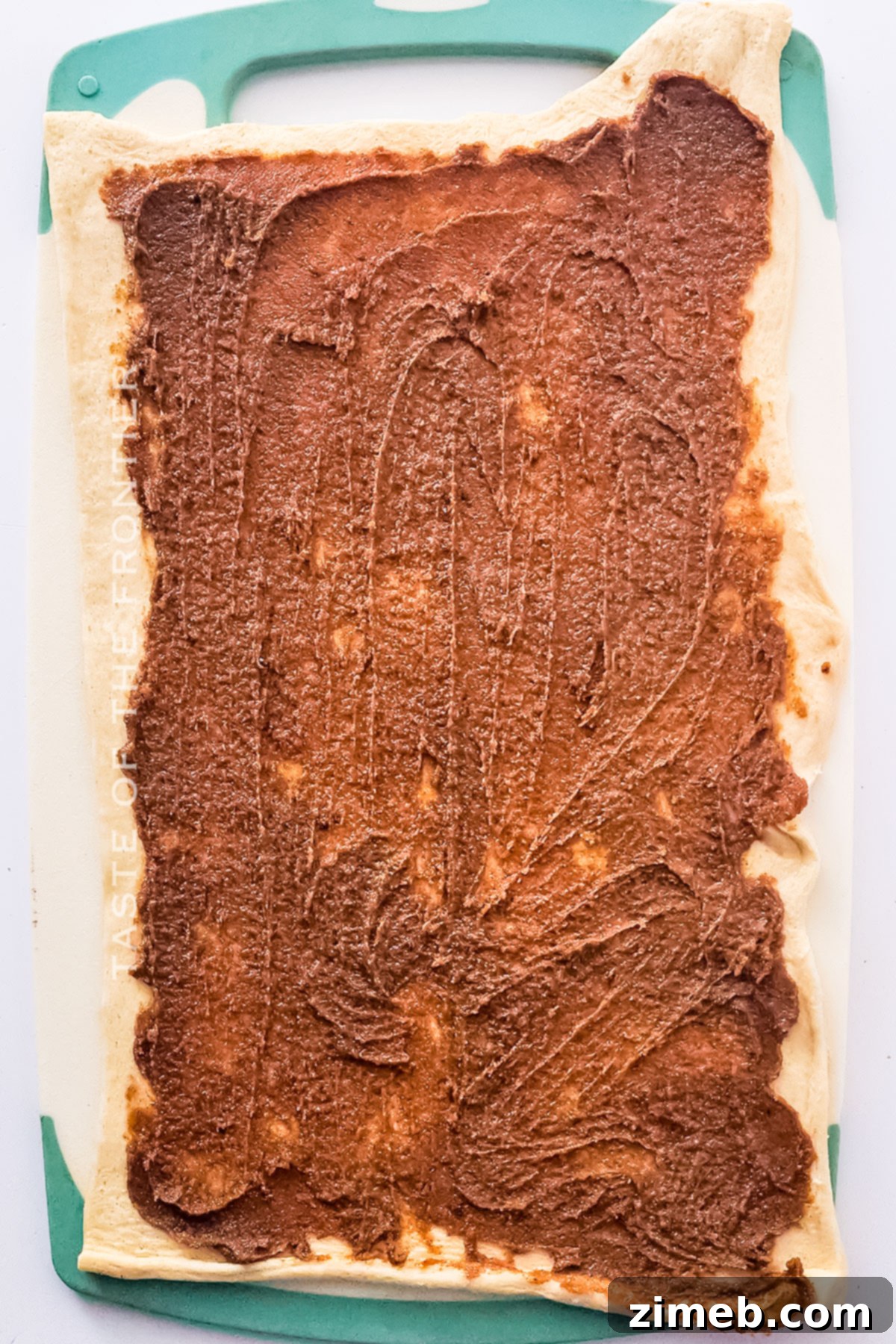 Close-up of a bowl filled with rich cinnamon filling made from butter, brown sugar, and cinnamon.