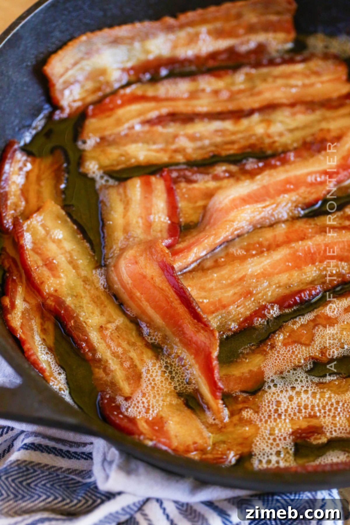 Gourmet Smoked Bacon 3 Fresh thick-cut bacon strips laid out in a cast iron skillet, ready for the Traeger smoker.