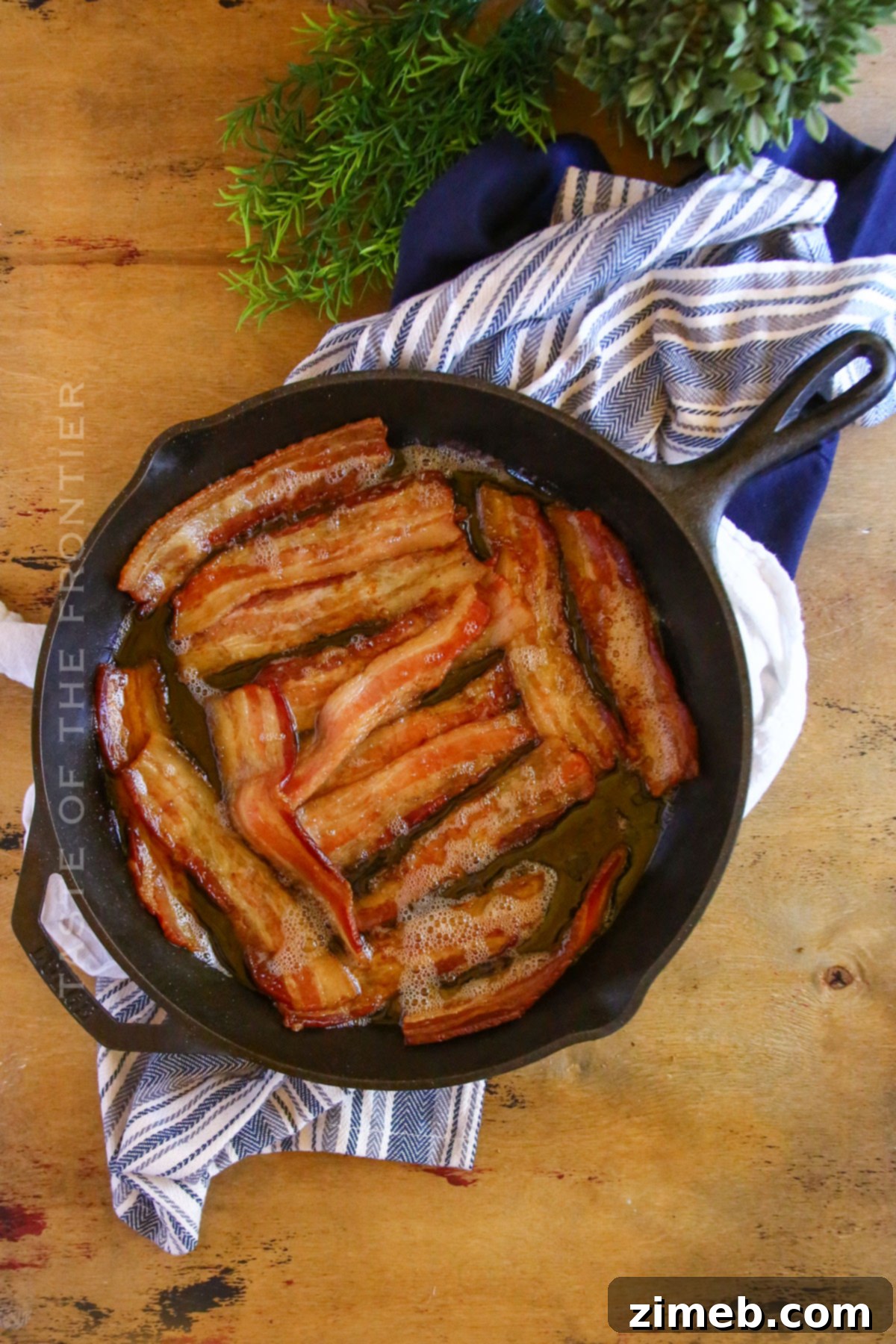 Gourmet Smoked Bacon 7 Perfectly cooked, crispy smoked bacon slices resting in a cast iron skillet.