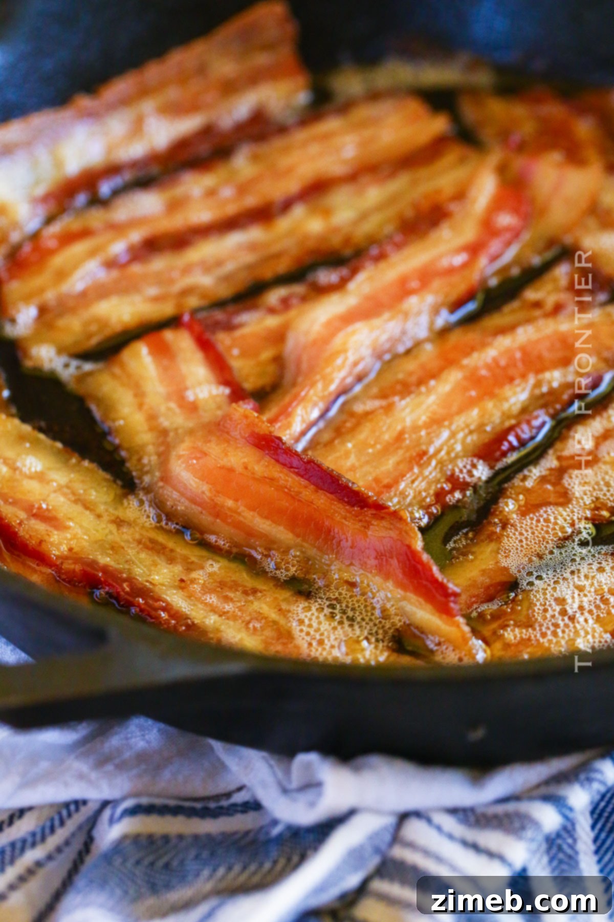 Gourmet Smoked Bacon 8 A close-up of easy-to-make smoked bacon, golden and sizzling on a smoker.