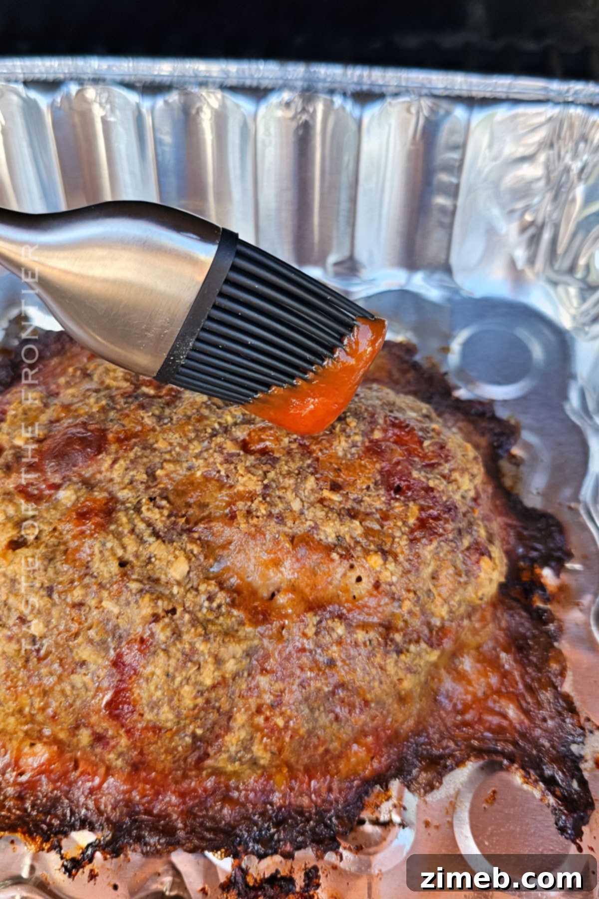 The Ultimate Smoked Meatloaf 8 adding ketchup to the top
