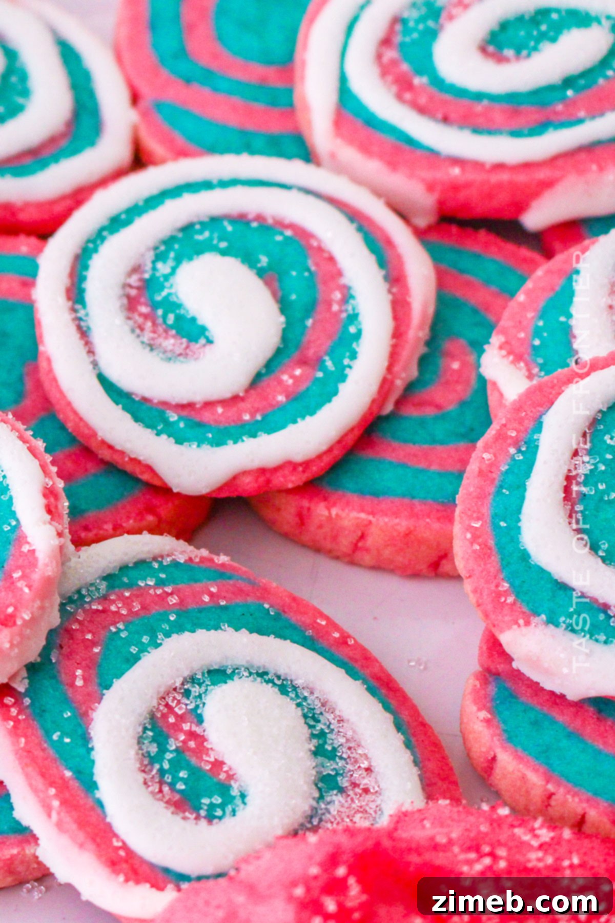 Pink and blue swirl cookies on a white plate