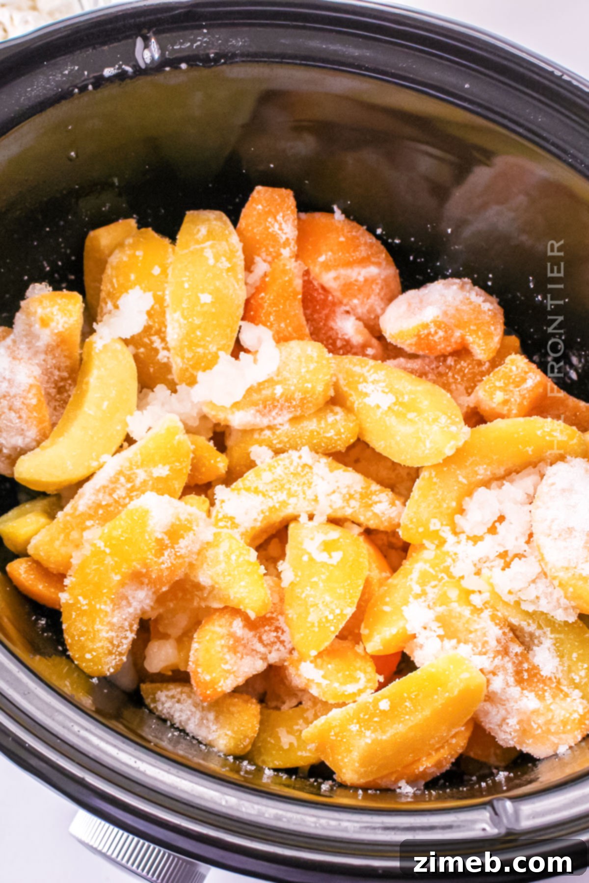 Effortless Slow Cooker Peach Cobbler with Bisquick 5 Frozen peaches ready for Slow Cooker Peach Cobbler