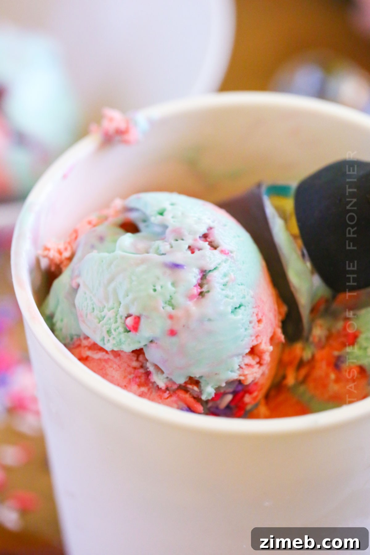 scooping homemade ice cream with sprinkles