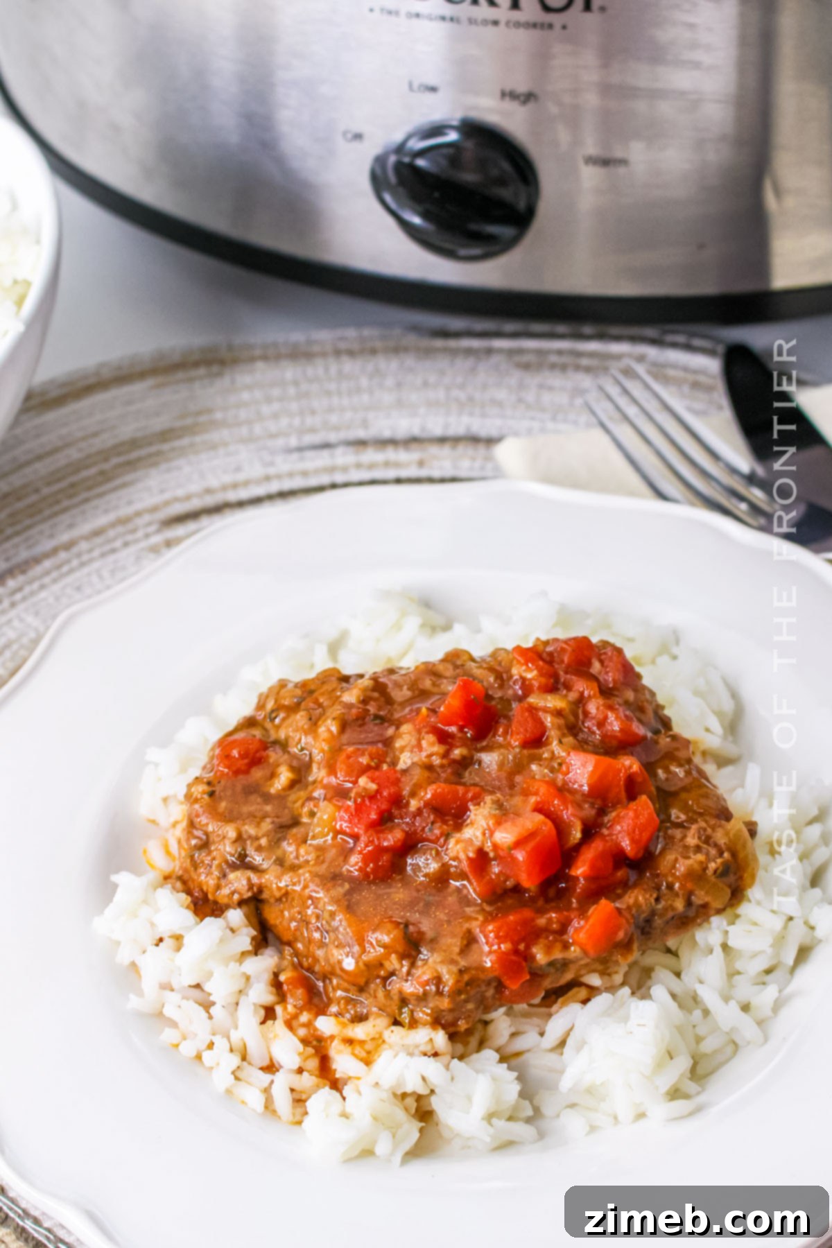 Comforting Slow Cooker Cubed Steak 3 Close up of Tender Cubed Steak with Tomatoes and Gravy