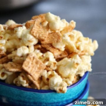 Instant Pot Movie Night Popcorn 9 A bowl of Cinnamon Toast Crunch popcorn, coated with a sweet cinnamon glaze, showing the crunchy cereal pieces mixed with the popcorn for a sweet and savory snack.