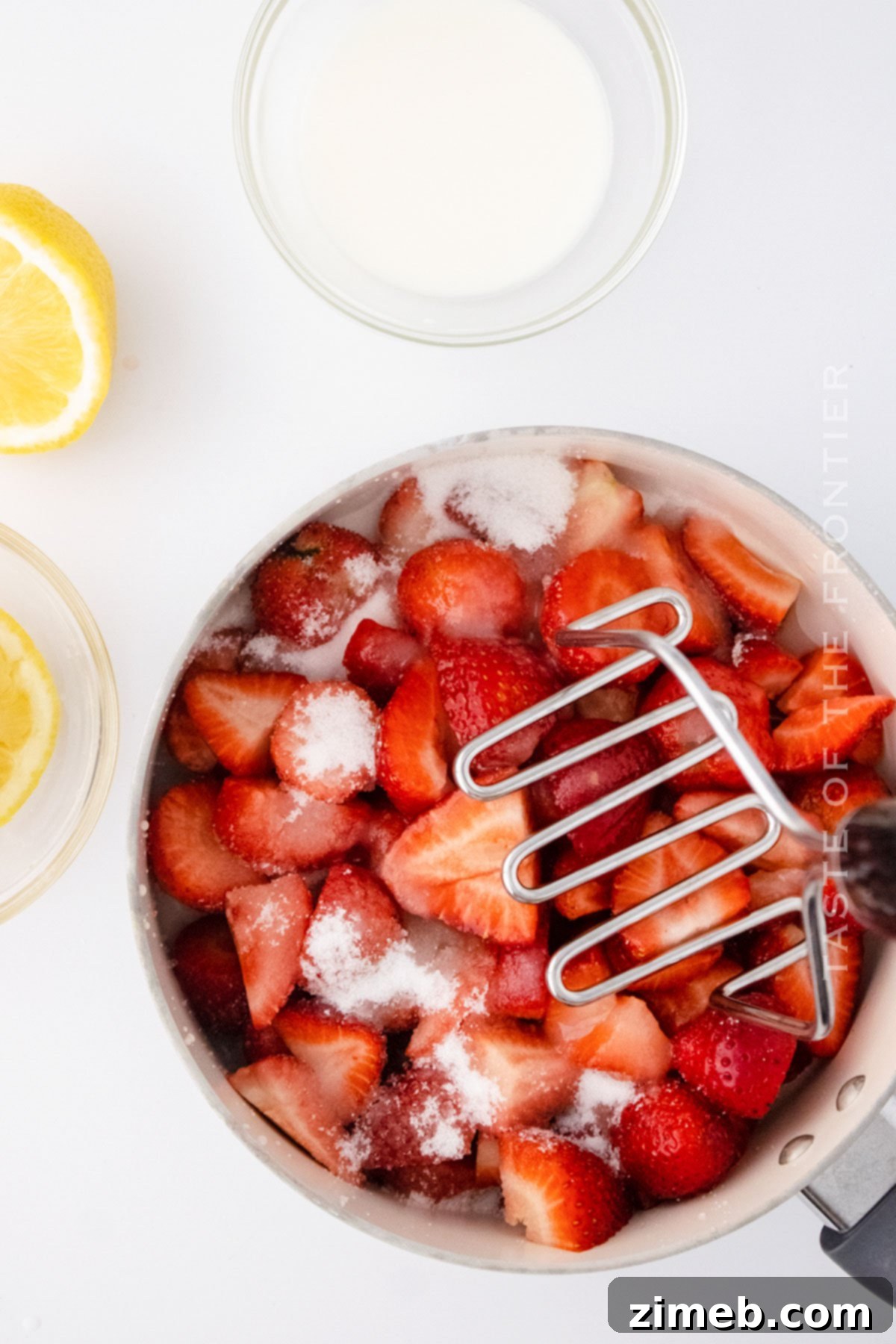 Mashing strawberries for jam