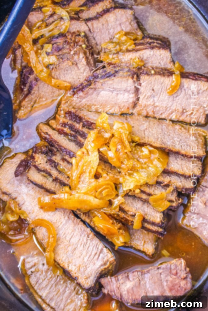 Melt-in-Your-Mouth Slow Cooker Flank Steak 5 Crockpot Flank Steak - A close-up of tender, sliced steak with onions