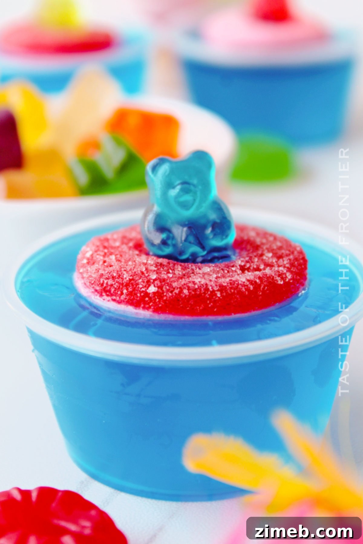 Vibrant blue Pool Party Jello Shots with gummy bears and rings, perfect for summer adult parties.