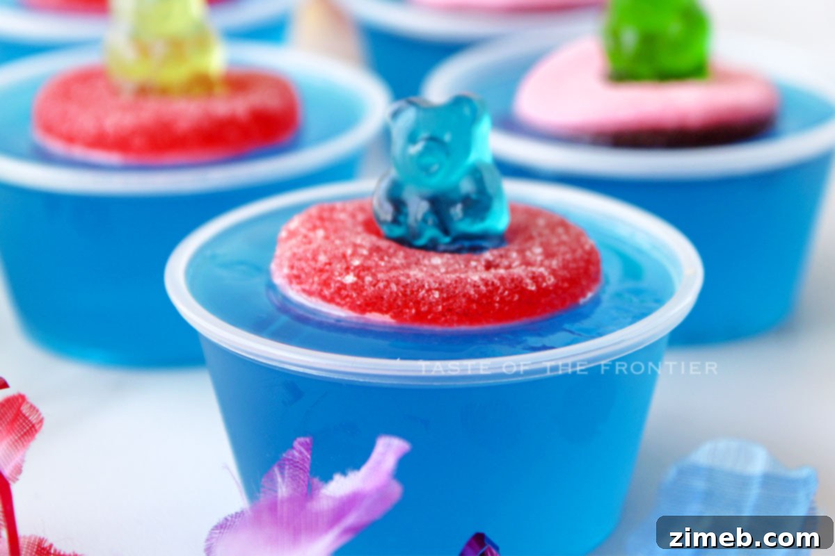 Close-up of three Pool Party Jello Shots for adults, showing cute gummy details.