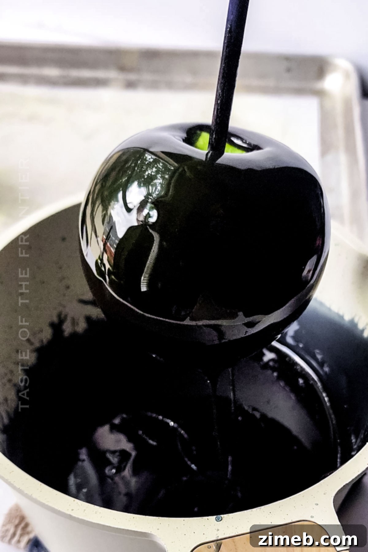 Midnight Candy Apples 6 Black candy coating dripping from a freshly dipped apple.