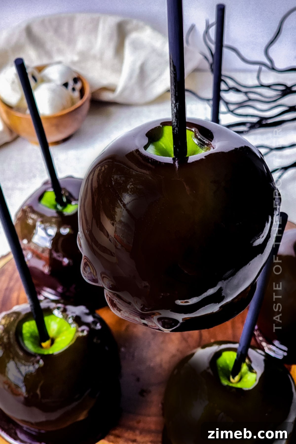 Midnight Candy Apples 8 Halloween-themed Black Candy Apples on a platter.