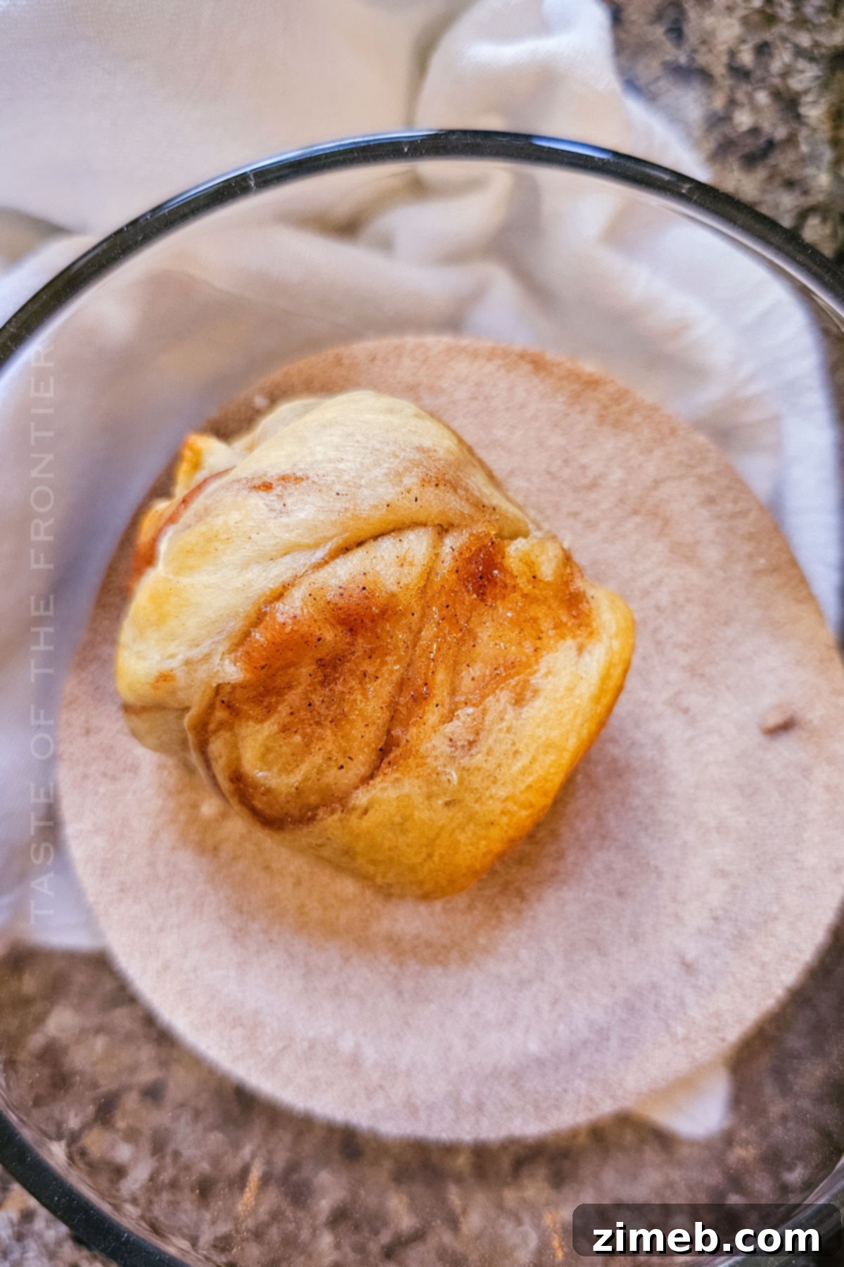 Rolling warm Apple Butter Cruffins in cinnamon sugar mixture