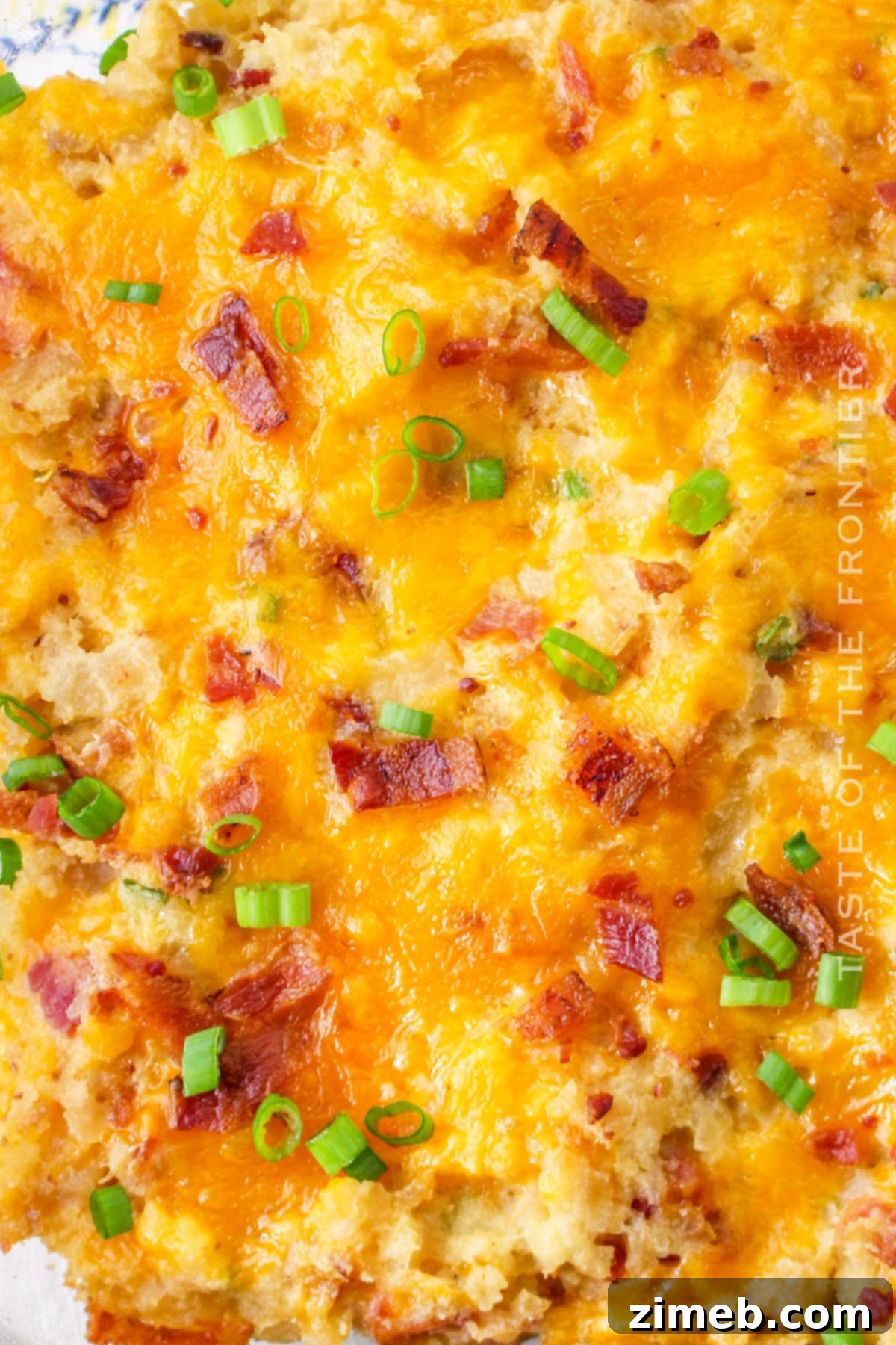 Easy Potato Casserole Recipe, overhead shot with serving spoon.
