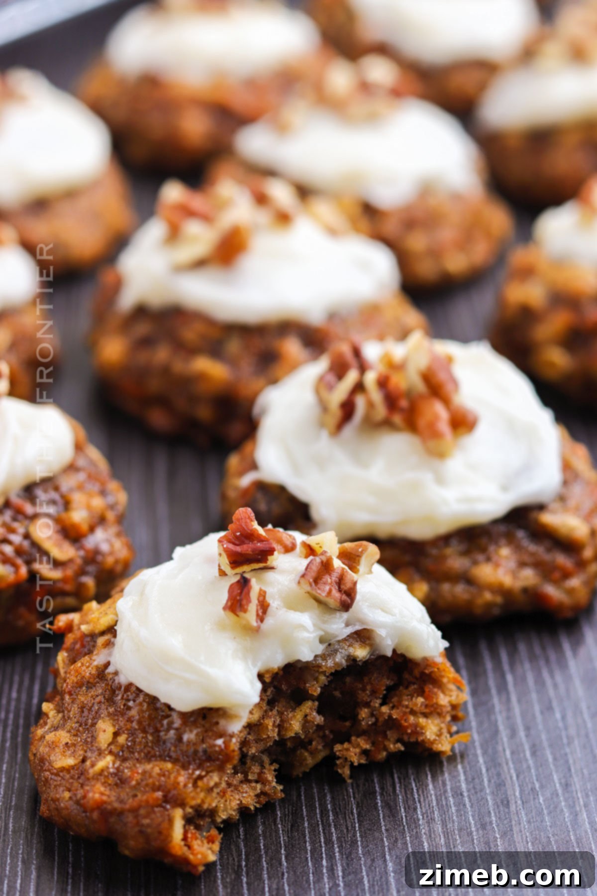 Stacked Carrot Cake Cookies, generously frosted and garnished with pecans, ready to serve