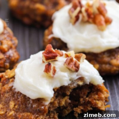 A single perfectly frosted Carrot Cake Cookie with pecans on top