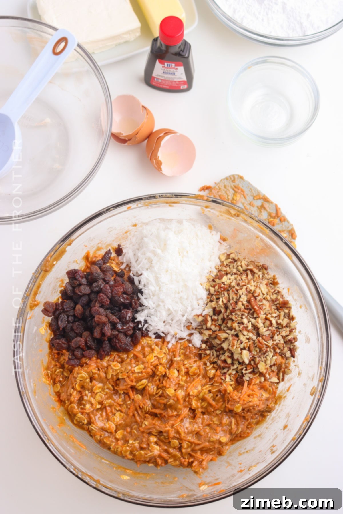 Close-up of Carrot Cake Cookie dough with grated carrots, oats, and pecans mixed in
