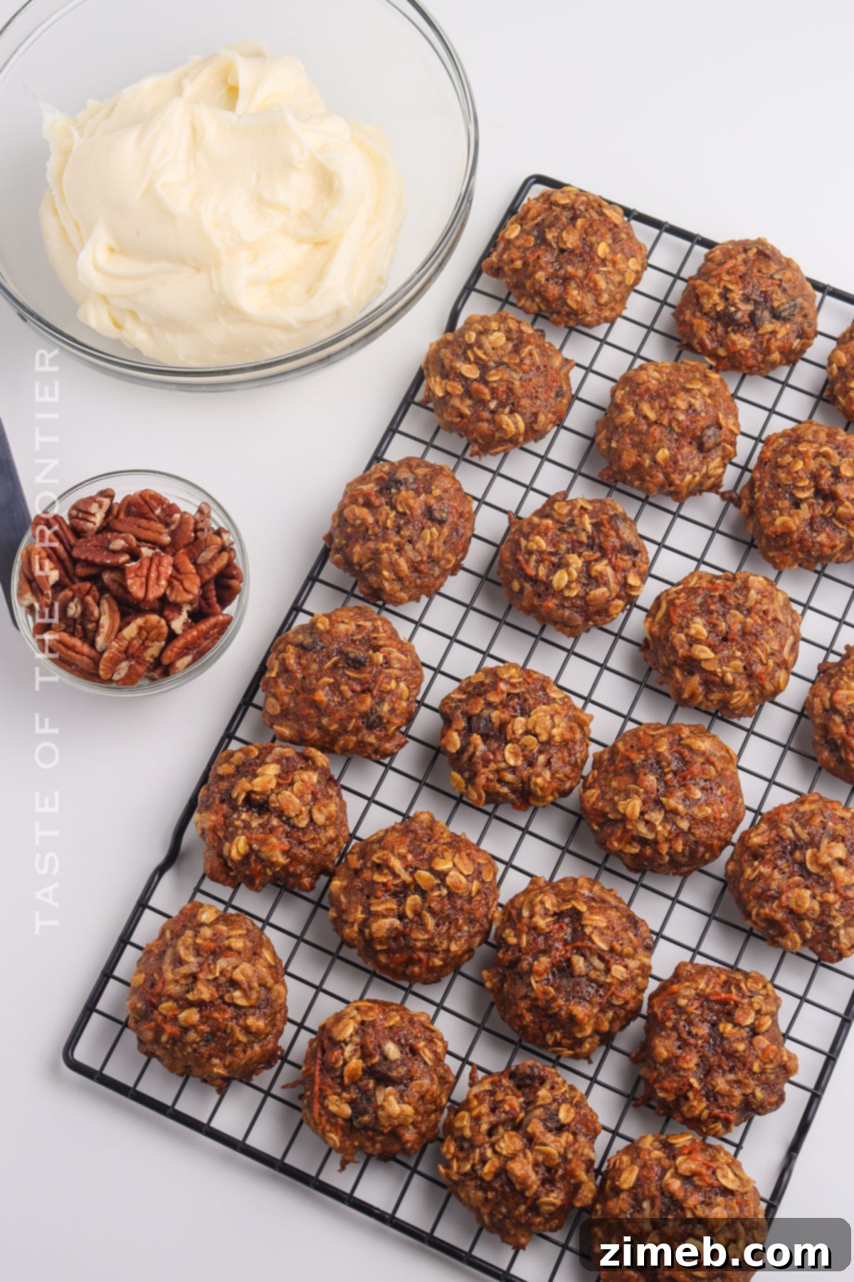 Decorating freshly baked Carrot Cake Cookies with creamy cream cheese frosting