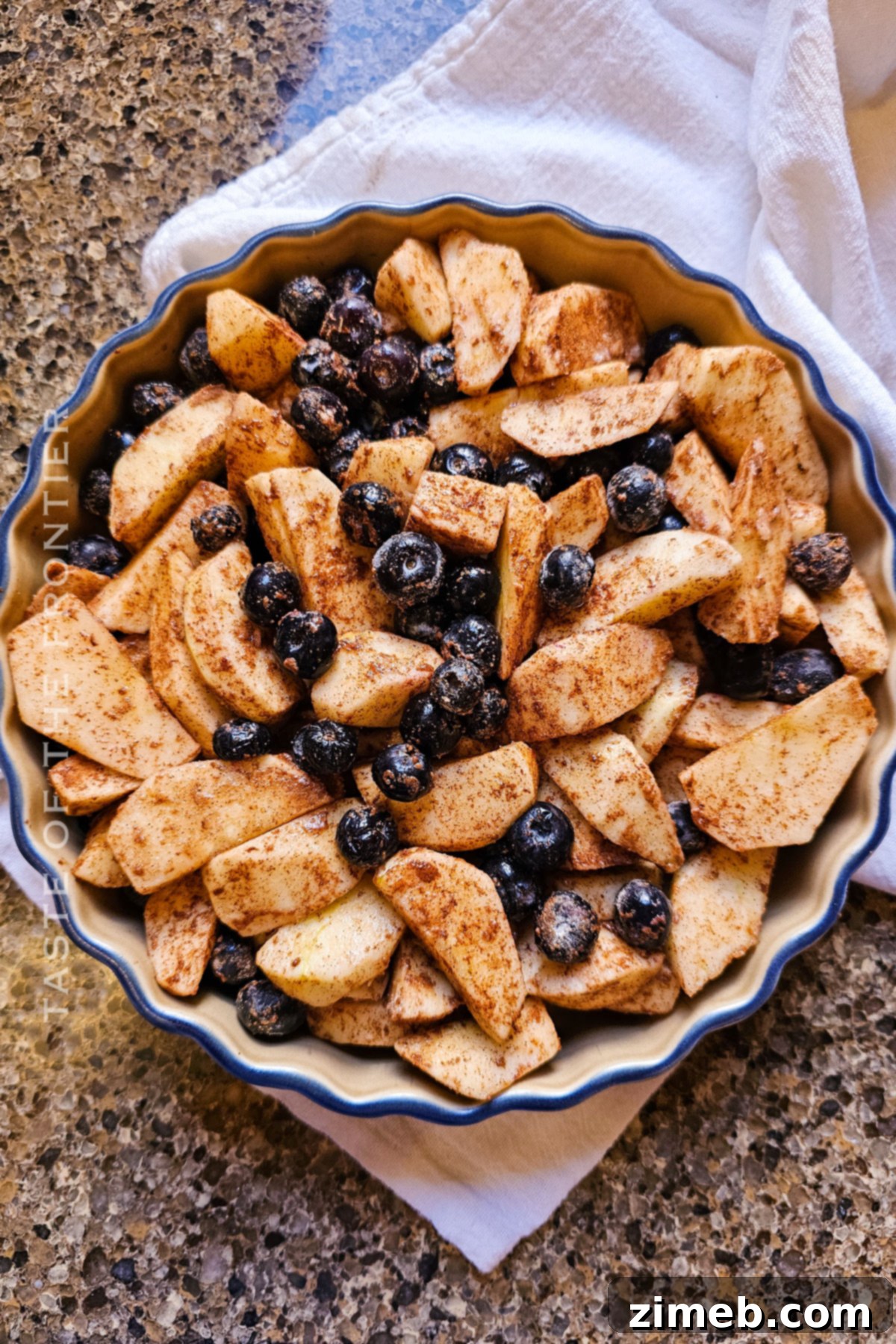 How to make Apple and Blueberry Crumble - Step-by-step assembly of fruit and topping in a baking dish.