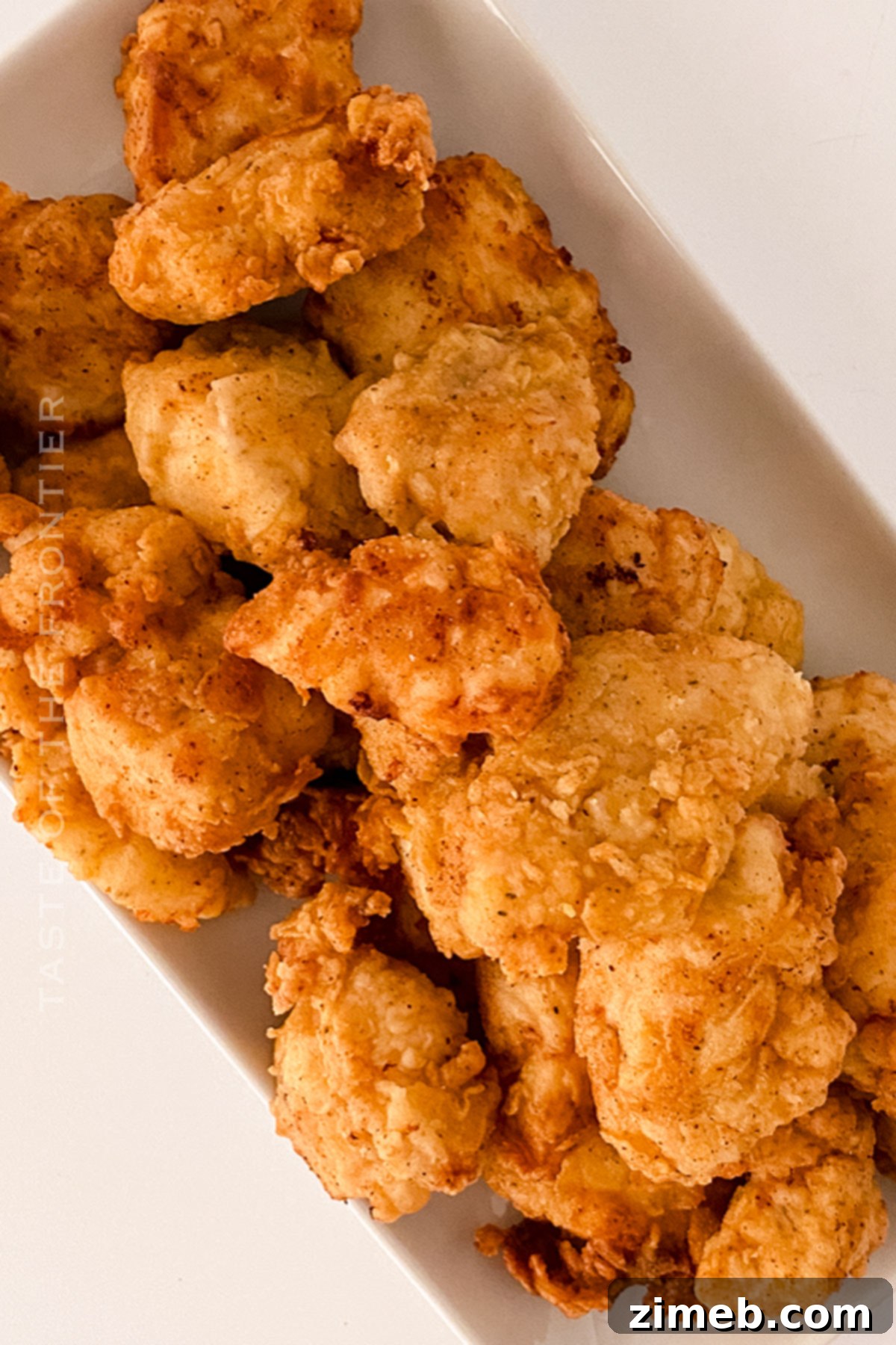 Perfectly Crispy Homemade Chicken Nuggets 3 Close-up of crispy golden chicken nuggets ready for dipping in various sauces