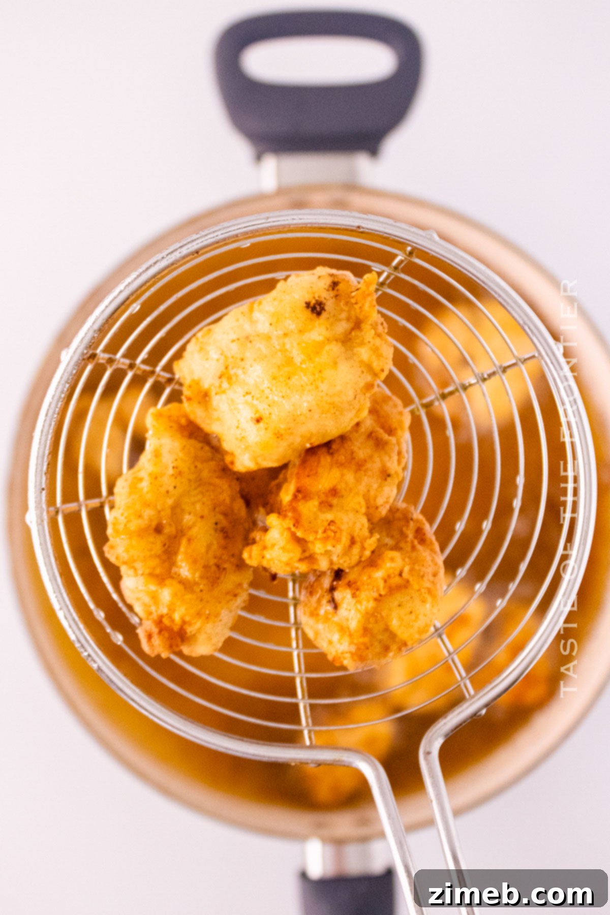 Perfectly Crispy Homemade Chicken Nuggets 6 Freshly fried golden chicken nugget pieces arranged on a platter ready to be served