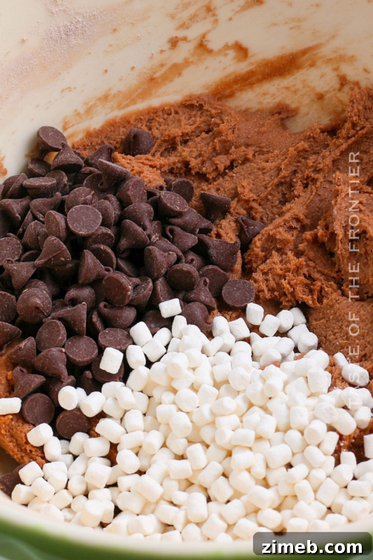 Mixing marshmallows and chocolate chips into cookie dough